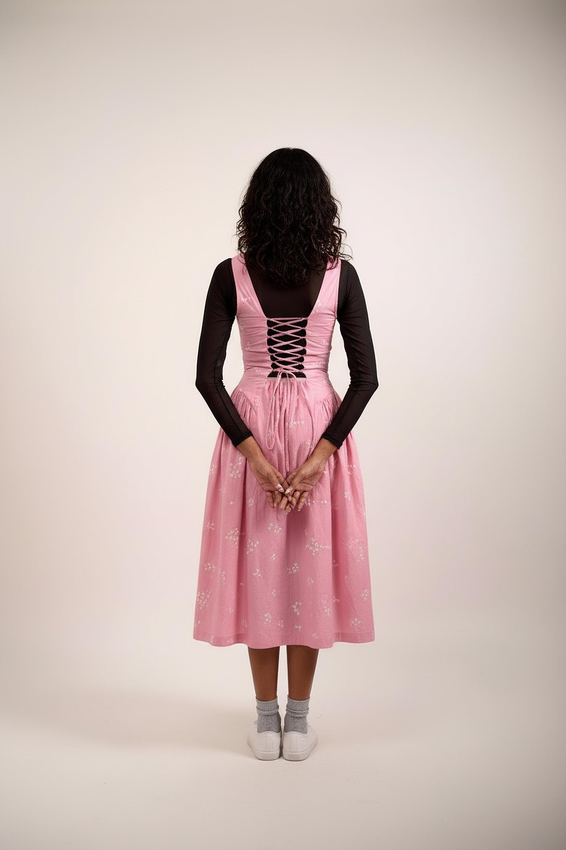 Back view of Doodlage Kyren bandhani dress with intricate traditional patterns and vibrant colors, showcasing the detailed design.