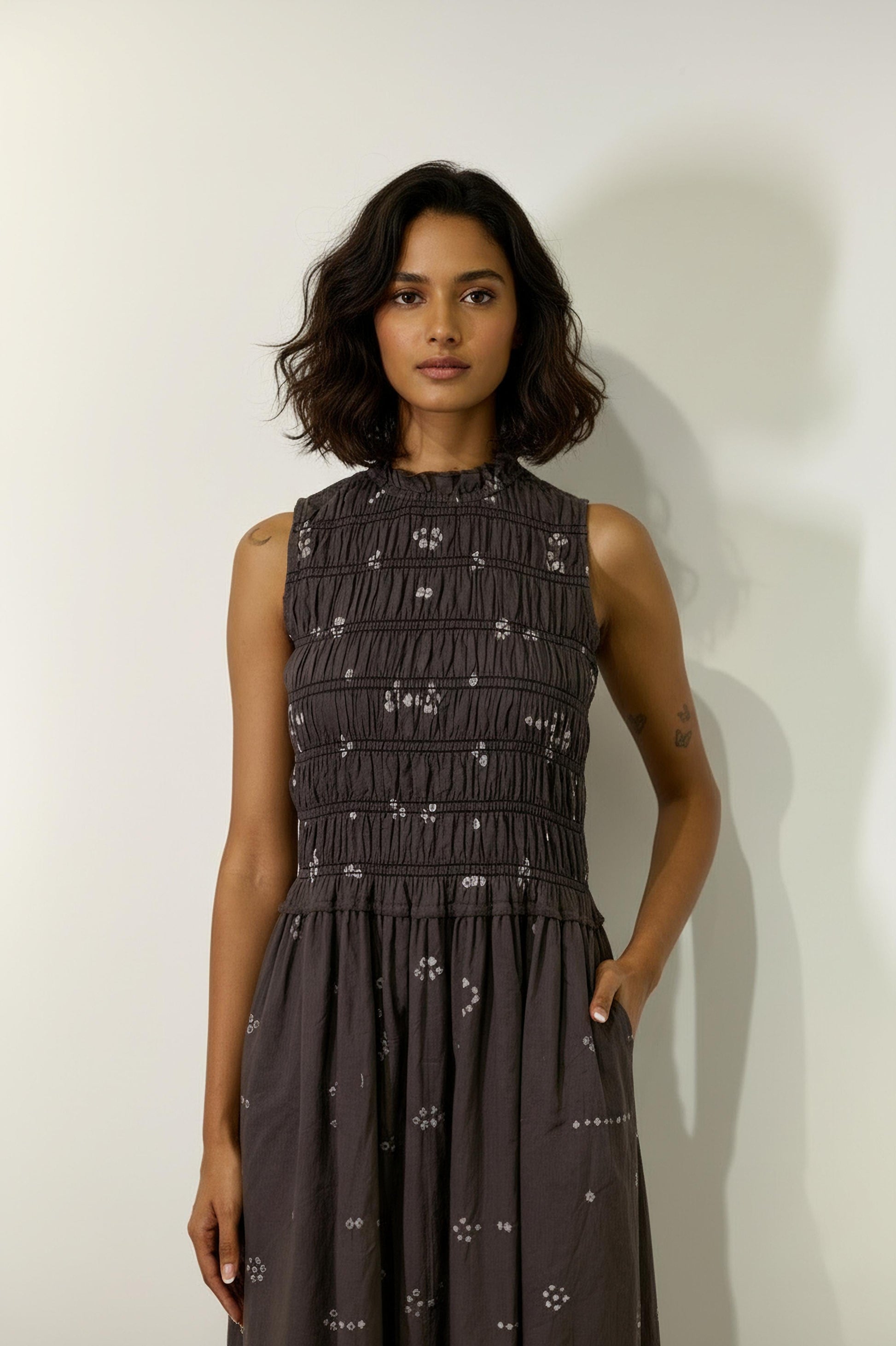 Doodlage Midsummer bandhani smocked dress displayed on a model with a clean background, showcasing its vibrant pattern and relaxed fit.