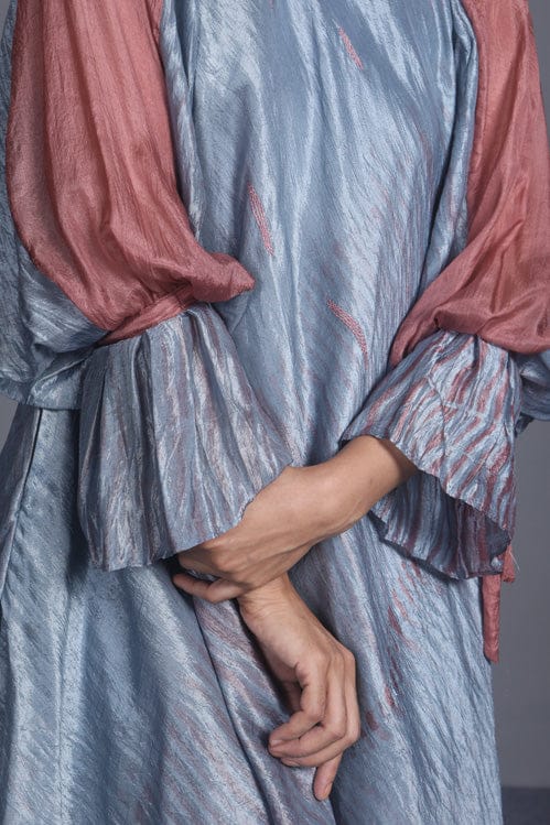 Blush and teal dress by Theloomart with floral pattern, sleeveless design, and elegant flowy fabric.
