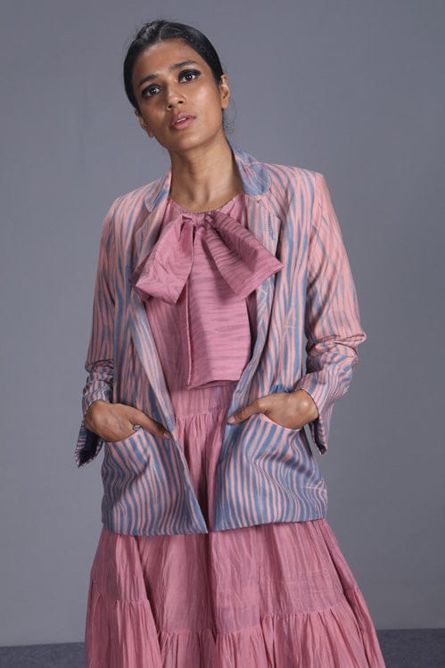 Coral silk jacket from Theloomart featuring a stylish, smooth fabric and classic design, displayed on a hanger.