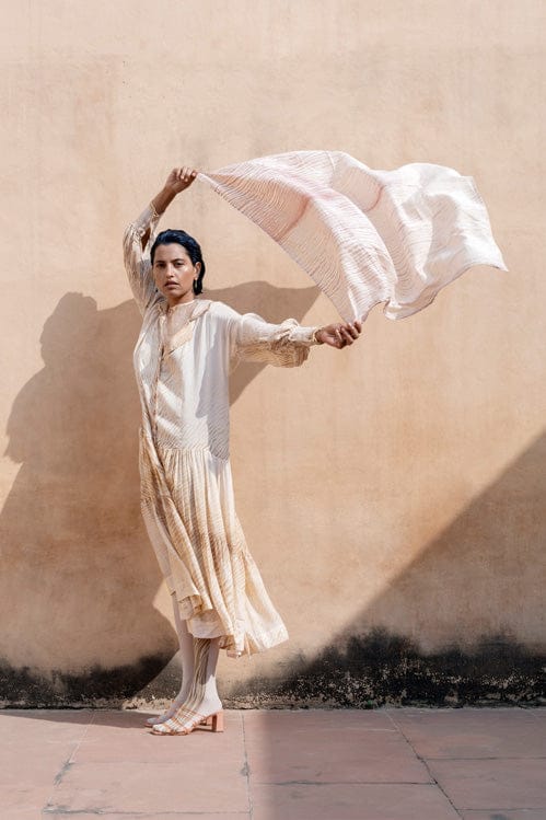 Theloomart Dreamy Dusk dress in soft pastel fabric with flowing design, displayed on a hanger against a neutral background.
