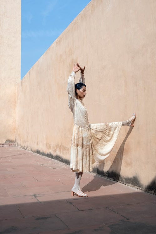 Dreamy dusk dress by Theloomart featuring a flowing silhouette and soft fabric, shown hanging on a wooden hanger.