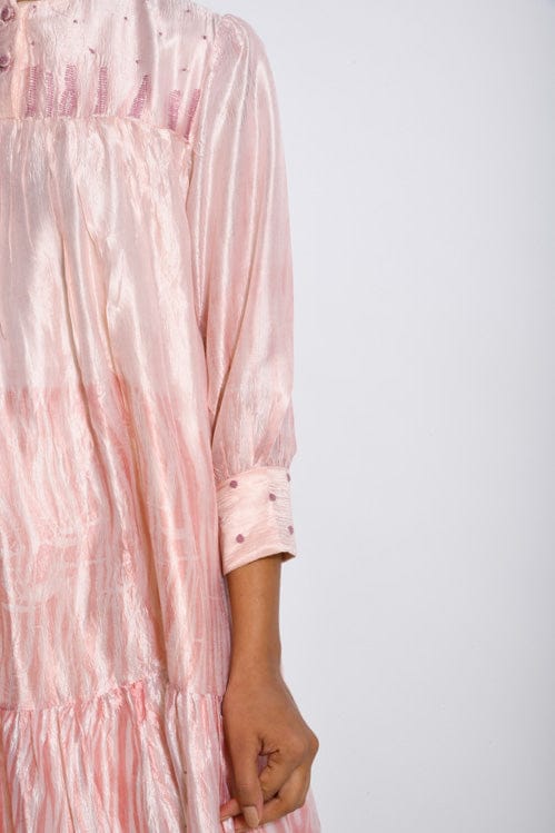 Ivory mist dress by Theloomart featuring a flowing fabric and elegant design, shown on a model.