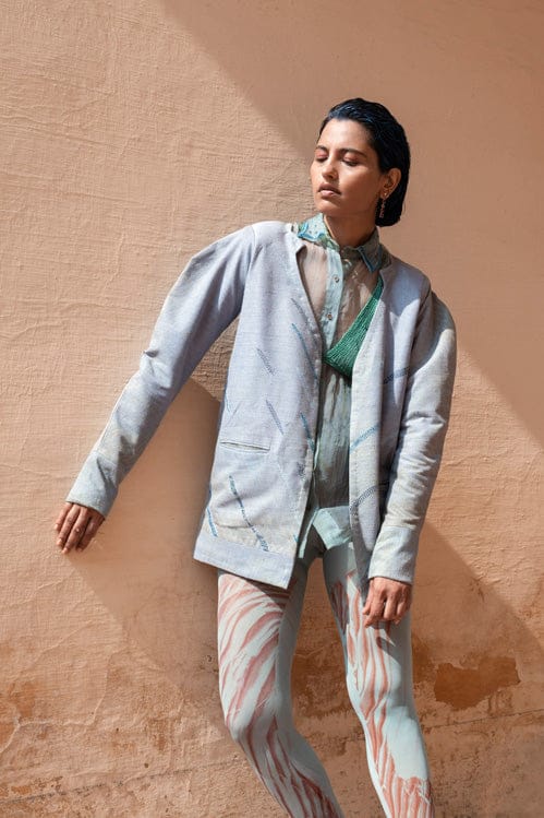 Flora & Fauna jacket by Theloomart featuring a colorful botanical print and lightweight fabric, displayed on a hanger.
