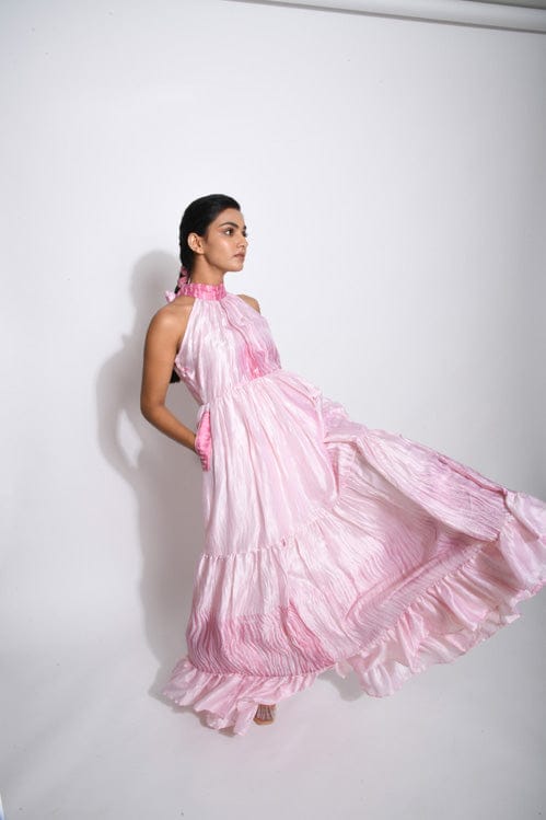 Theloomart Carolina rose dress displayed on a hanger, featuring floral patterns and a flowing fabric design.