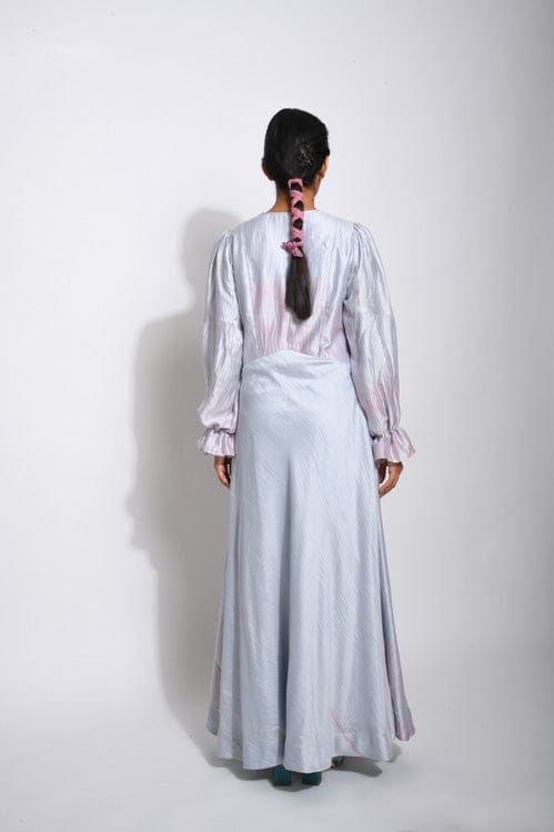 Elegant Persian silk dress from Theloomart featuring intricate patterns and flowing fabric, displayed on a hanger.