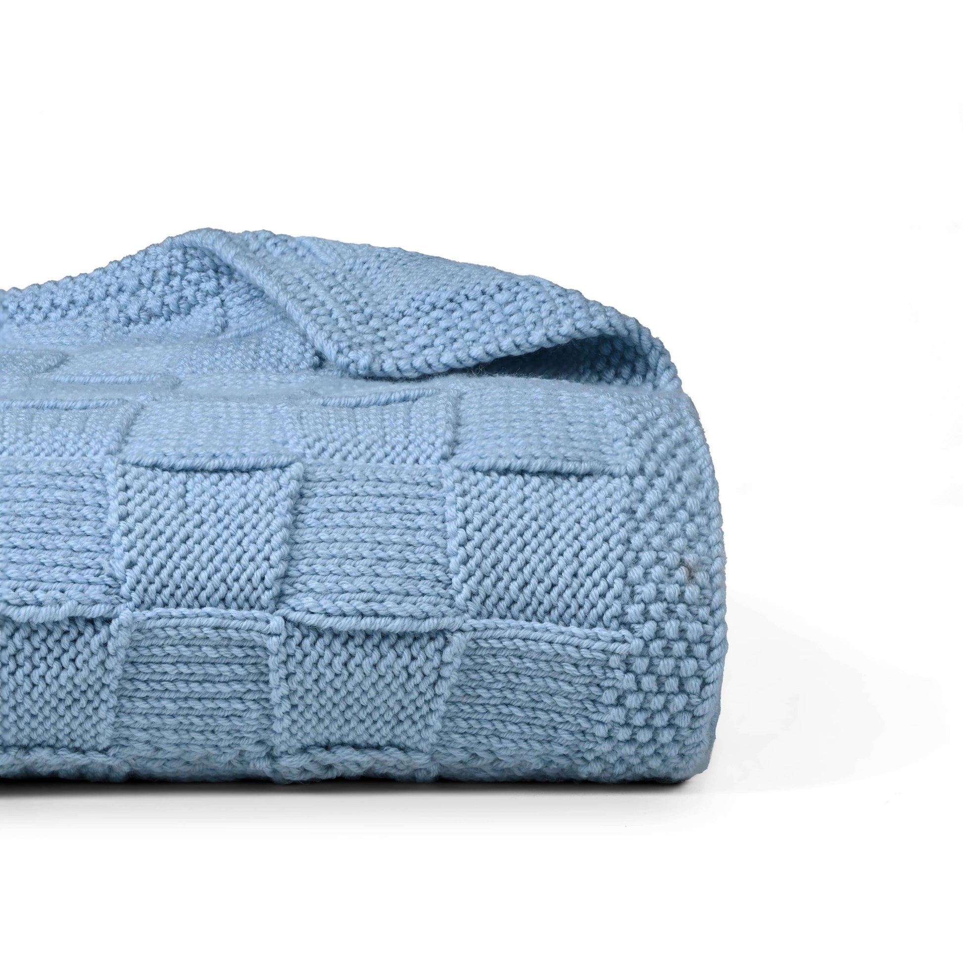 Blue Merino wool blanket by Masaya Home, showing soft, cozy fabric draped neatly for a warm, inviting look.