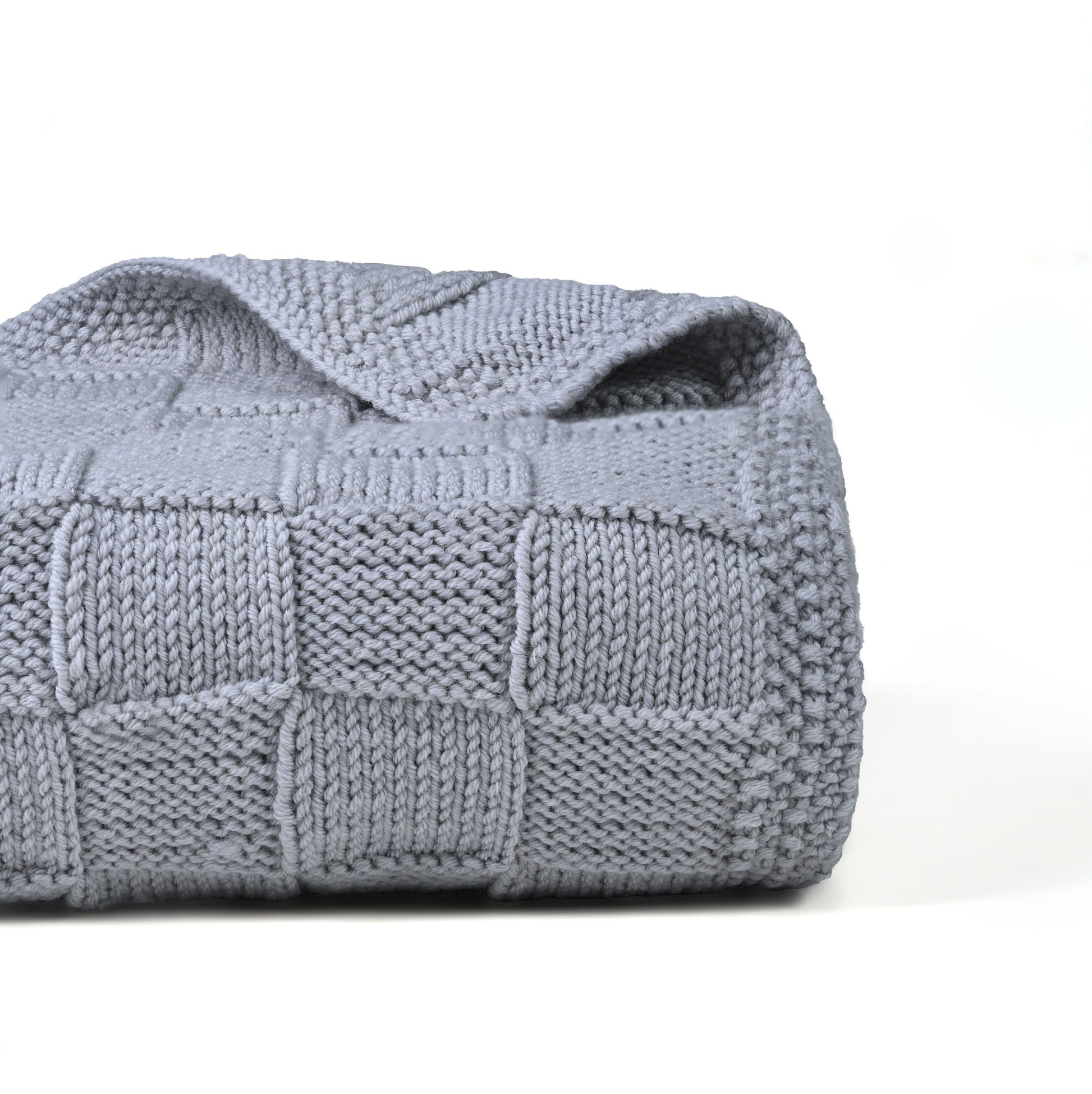 Gray Merino wool blanket from Masaya Home, showing soft, cozy fabric draped over a bed or sofa.