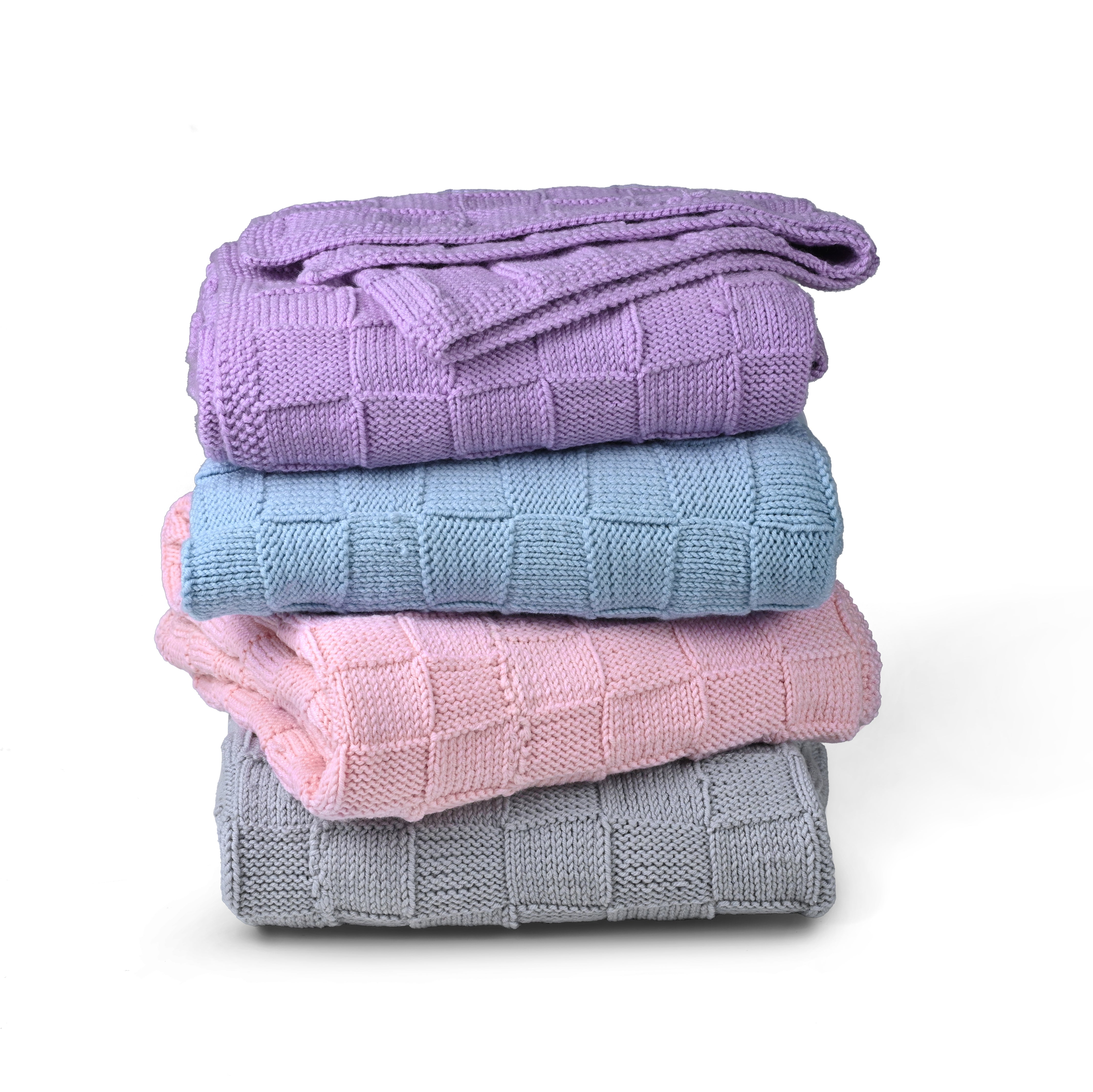 Purple Merino wool blanket by Masaya Home, soft and cozy with a plush texture, draped over a bed or sofa.
