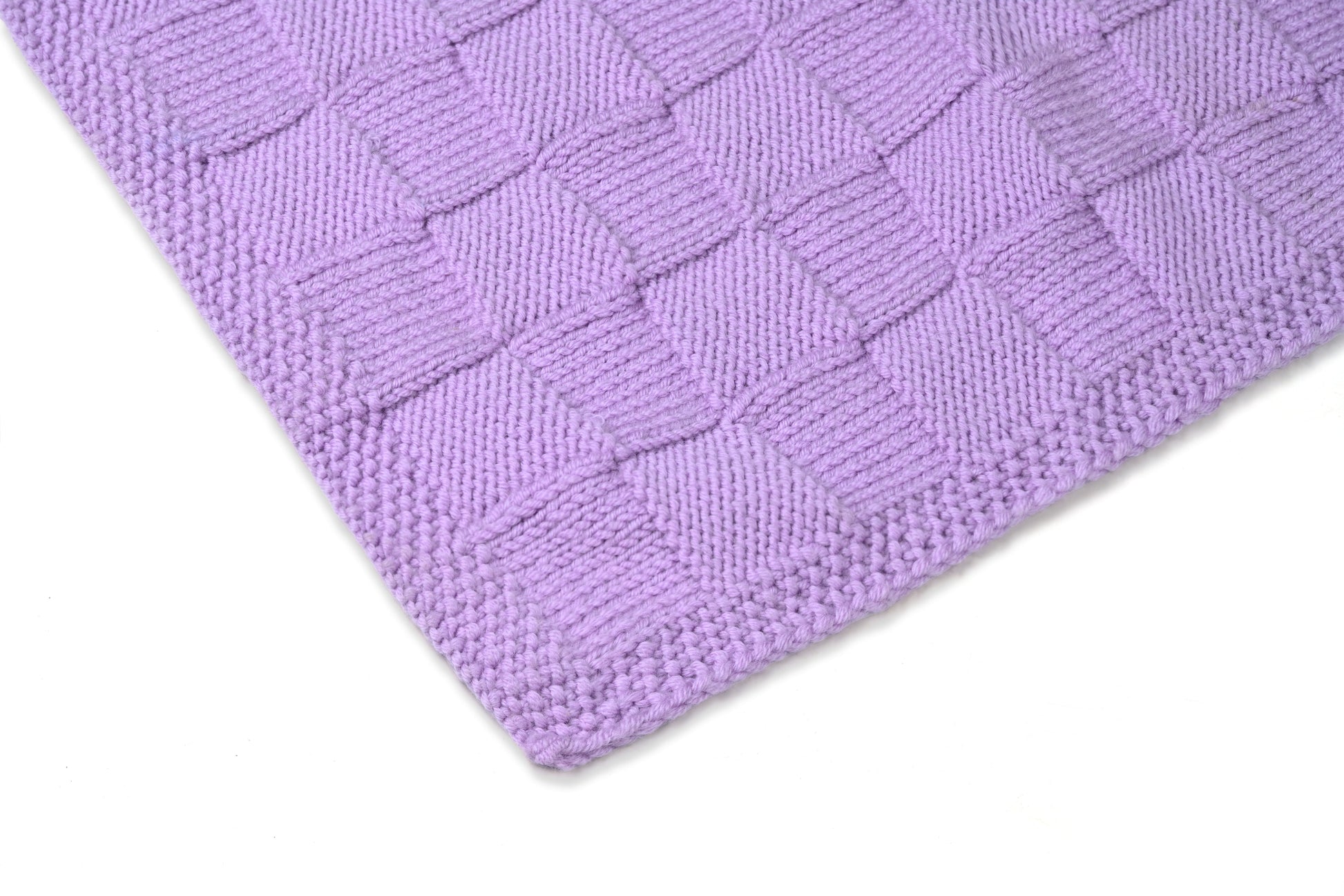 Purple Merino wool blanket by Masaya Home, soft and cozy with a textured knit pattern, draped on a bed or sofa.