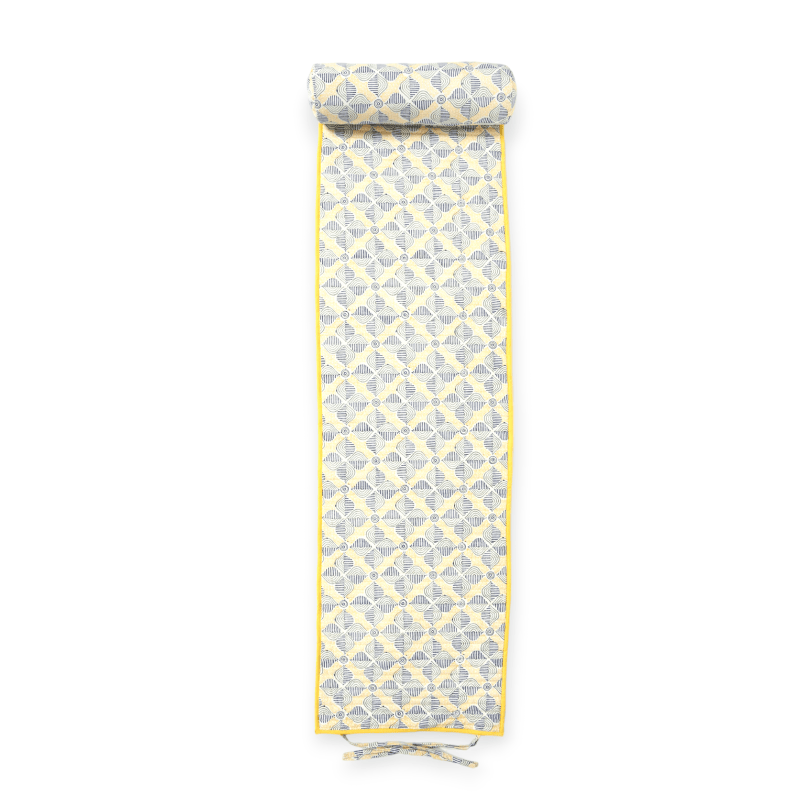 Bright lime beach mat by Bombaybirds with colorful striped edges, spread on sandy beach for lounging and sunbathing.