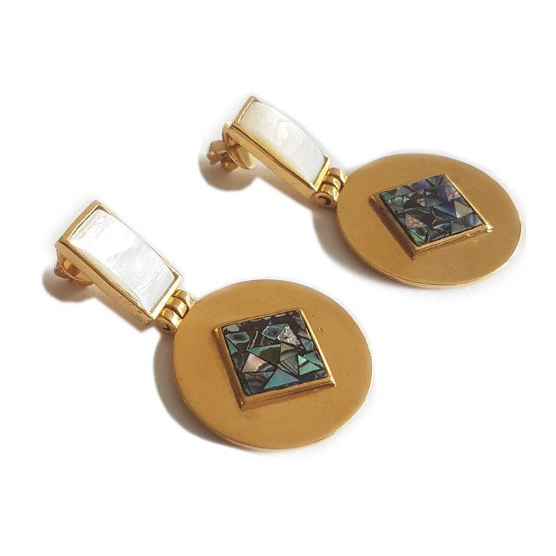 Close-up of Bombaybirds Mya earrings, silver hoop earrings with intricate design, hanging from earlobes.