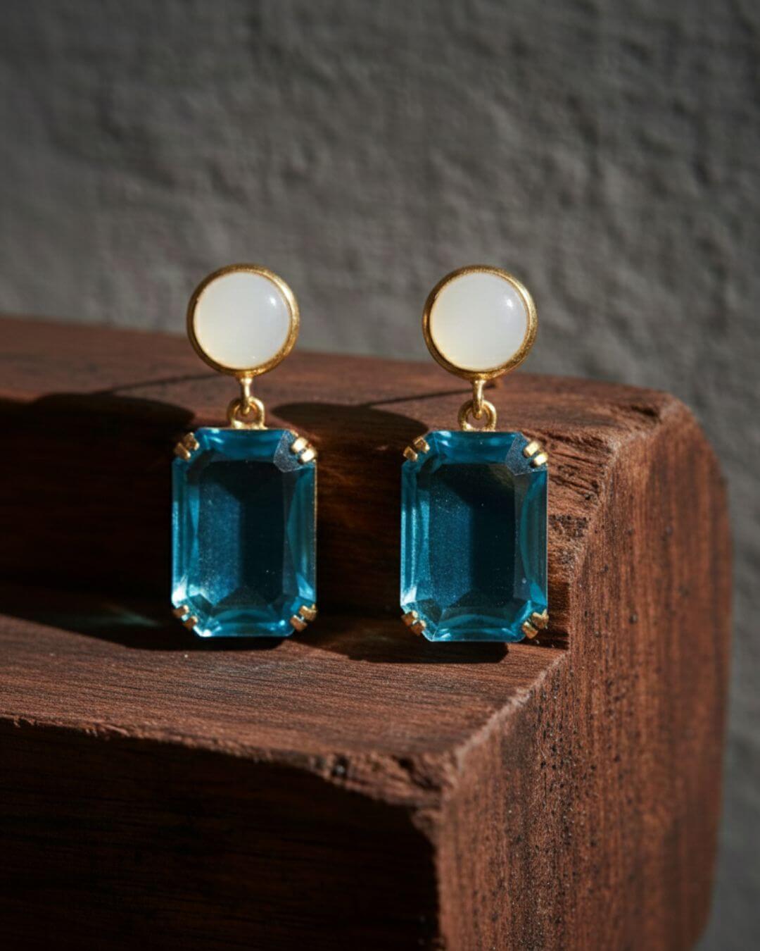 Noori earrings by Bombaybirds, silver-toned dangling earrings with intricate design and bead accents, hanging against a neutral background.