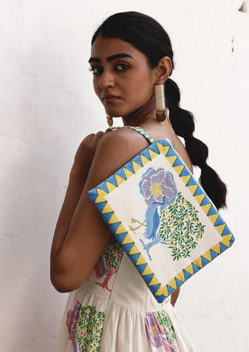 The Raw India Saras Crane pouch bag featuring a vibrant crane design, made from eco-friendly materials, with a zipper closure.