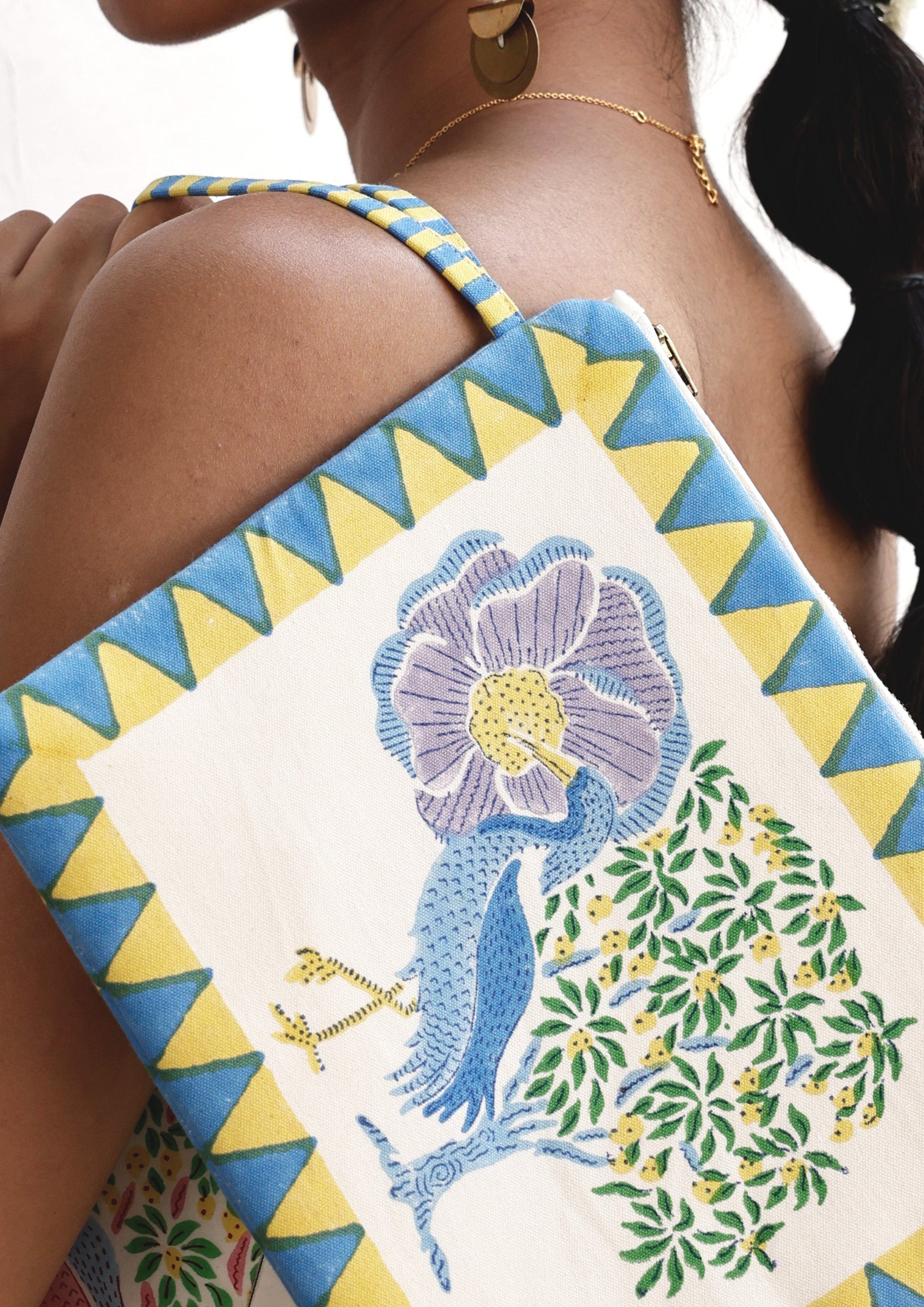 Leather pouch with a Saras Crane design by The Raw India, featuring intricate embroidery and a compact, stylish bag shape.