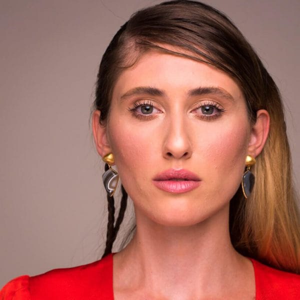 Bombaybirds Junon earrings featuring intricate silver design and dangling elements on a white background.