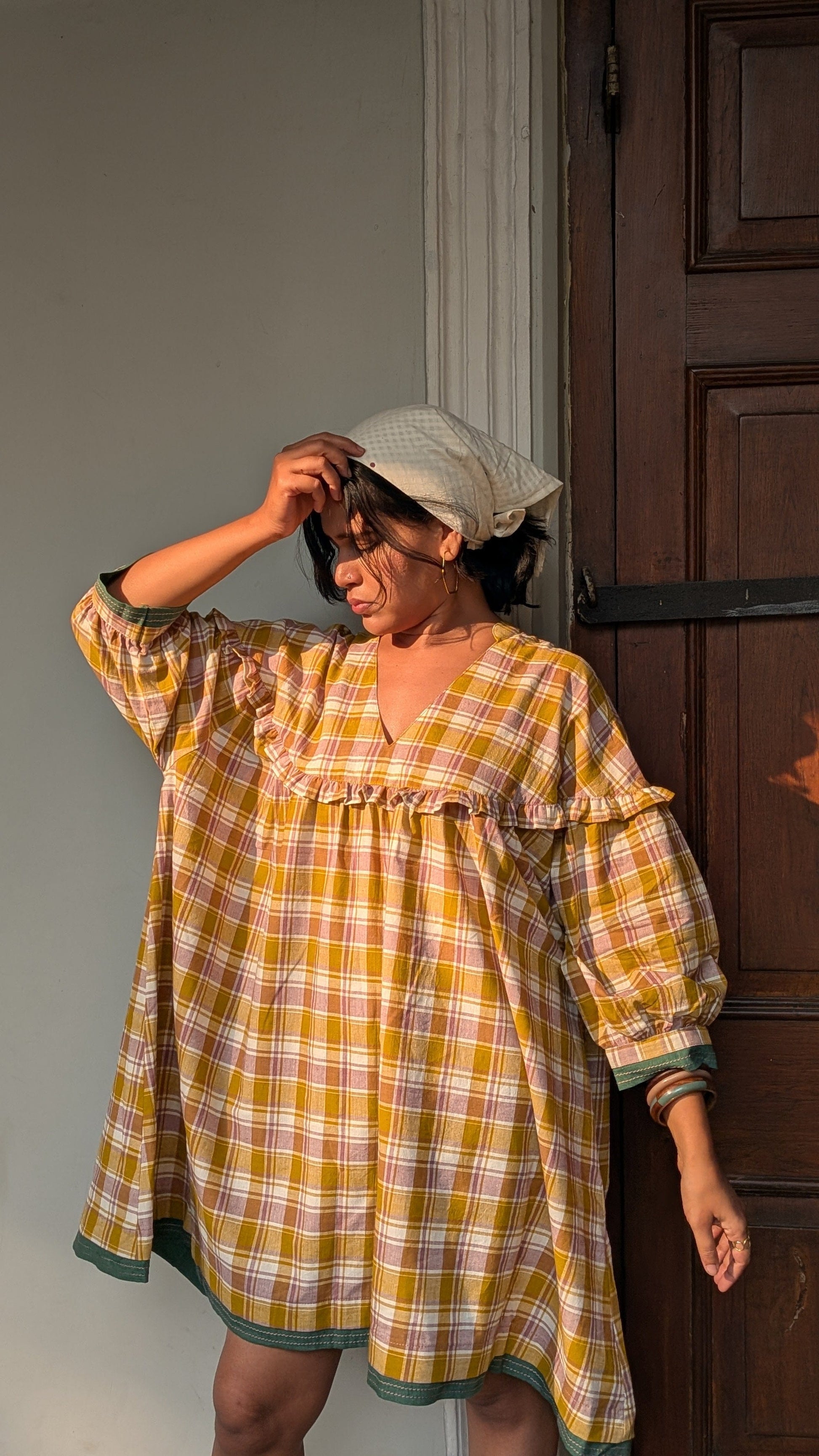 Deeta Ella tunic top in soft fabric with a relaxed fit, featuring a round neckline and long sleeves, shown in a portrait view.