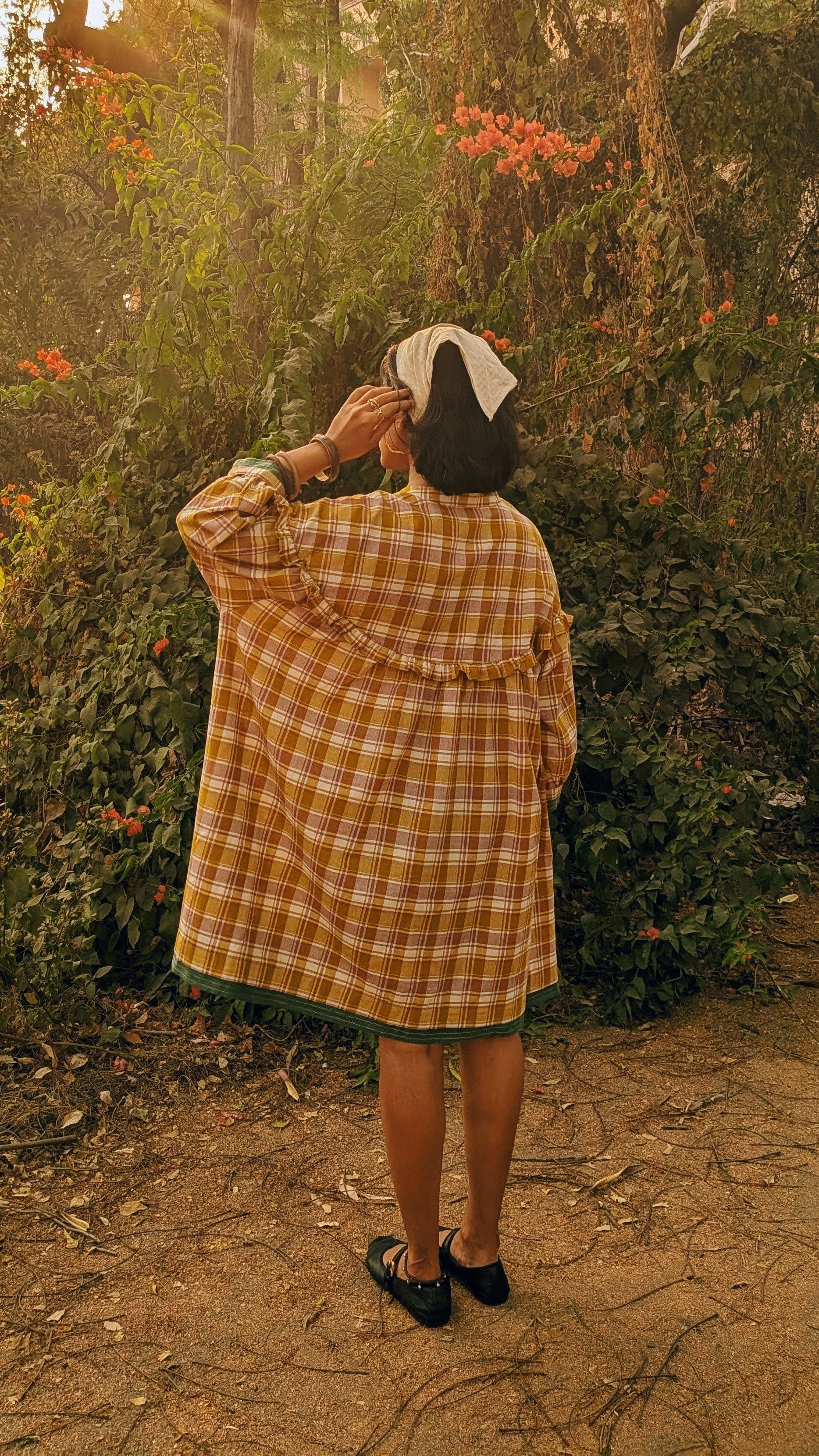 Deeta Ella tunic top with long sleeves and relaxed fit, displayed on a hanger with a neutral background.