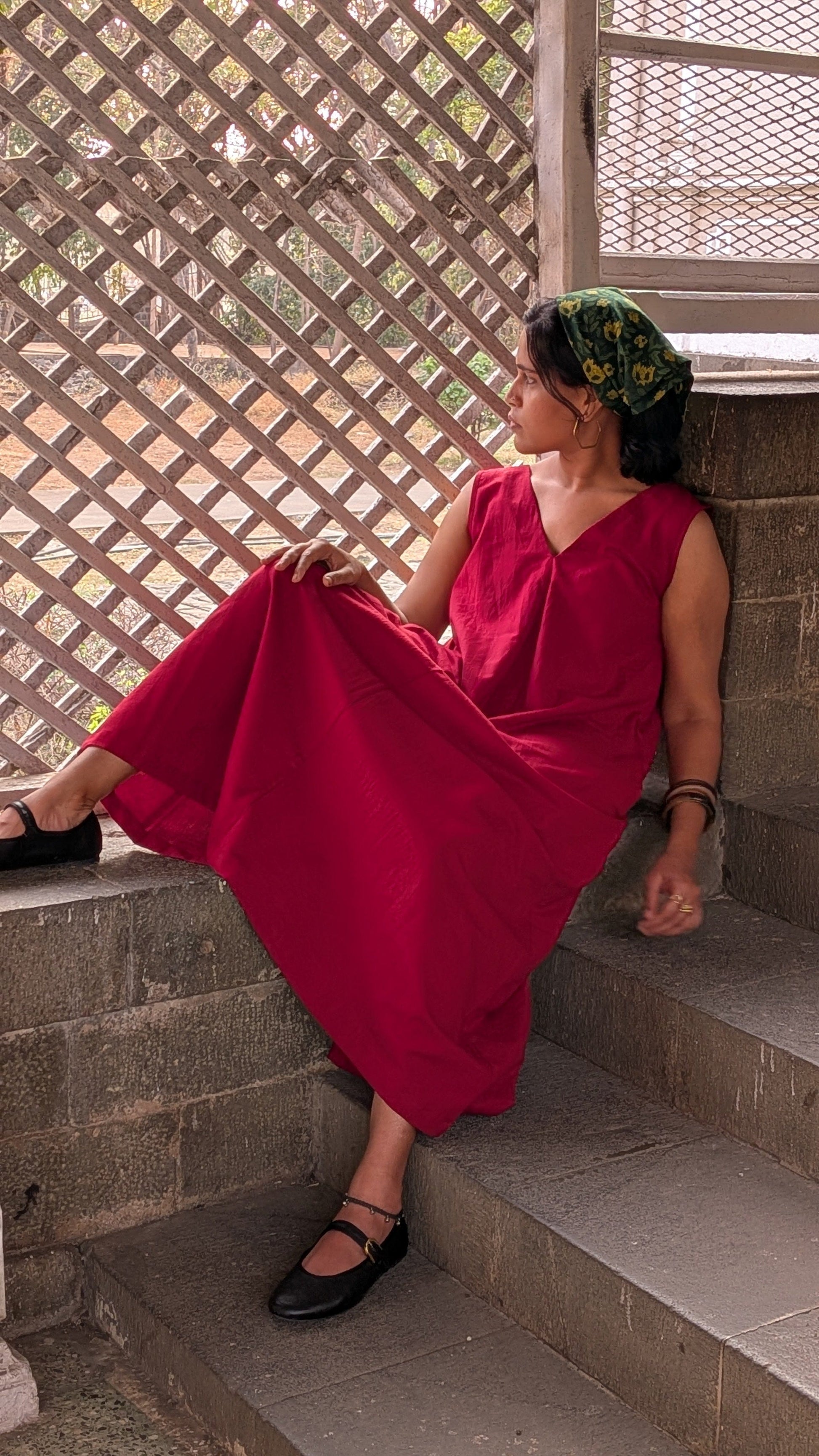Deeta Ruby dress shown in a portrait image, featuring a stylish red dress with a fitted design and elegant neckline.