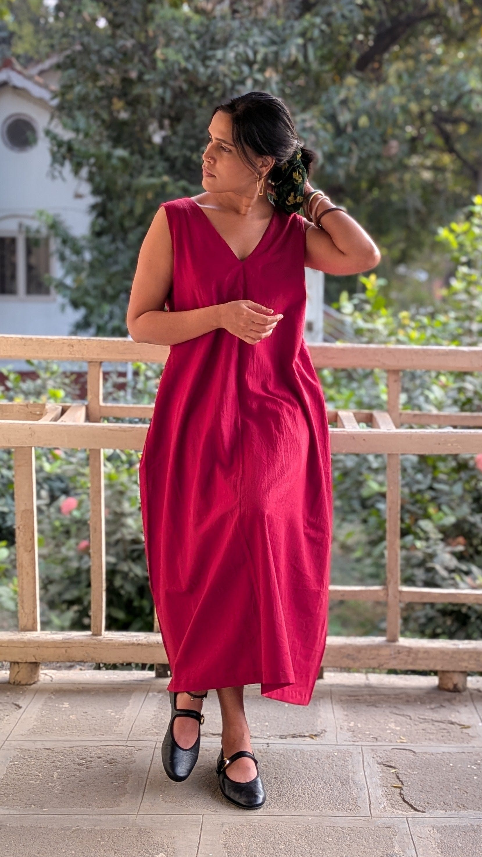 Deeta ruby dress shown on a model, featuring a stylish fit and vibrant red color, perfect for elegant occasions.