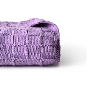 Purple Merino wool blanket by Masaya Home, showcasing soft, cozy fabric with a textured weave and fringed edges.