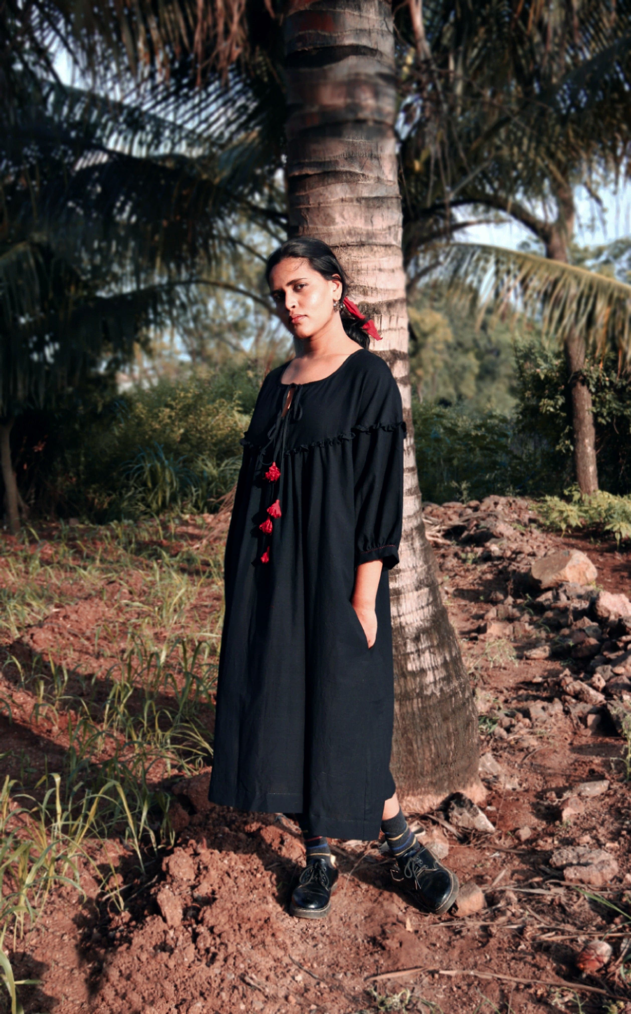 Black Raven dress by Deeta featuring a stylish, elegant design with a fitted silhouette and detailed fabric texture.