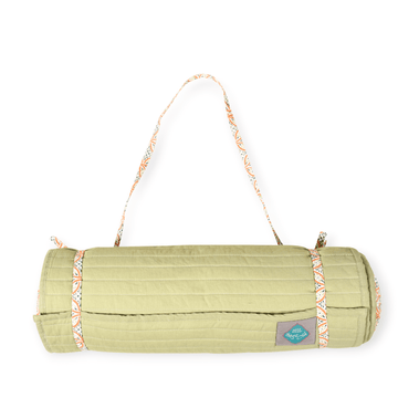 Bombaybirds Pista beach mat displayed outdoors with a woven design, ideal for beach or outdoor relaxation.