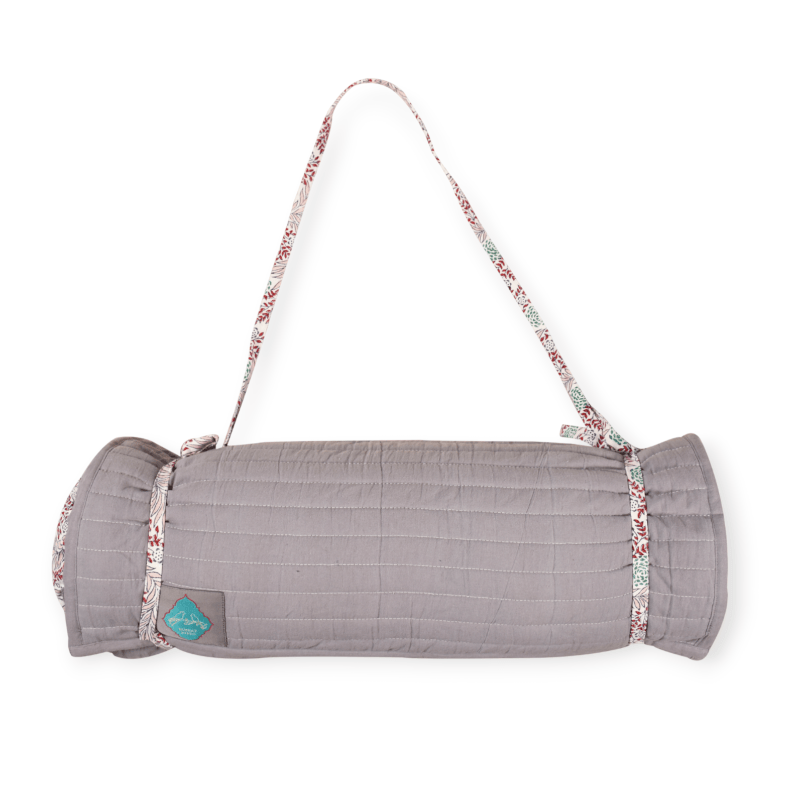 Bombaybirds sandy beach mat laid out on sand, showcasing its durable, woven outdoor design perfect for beach outings and lounging.