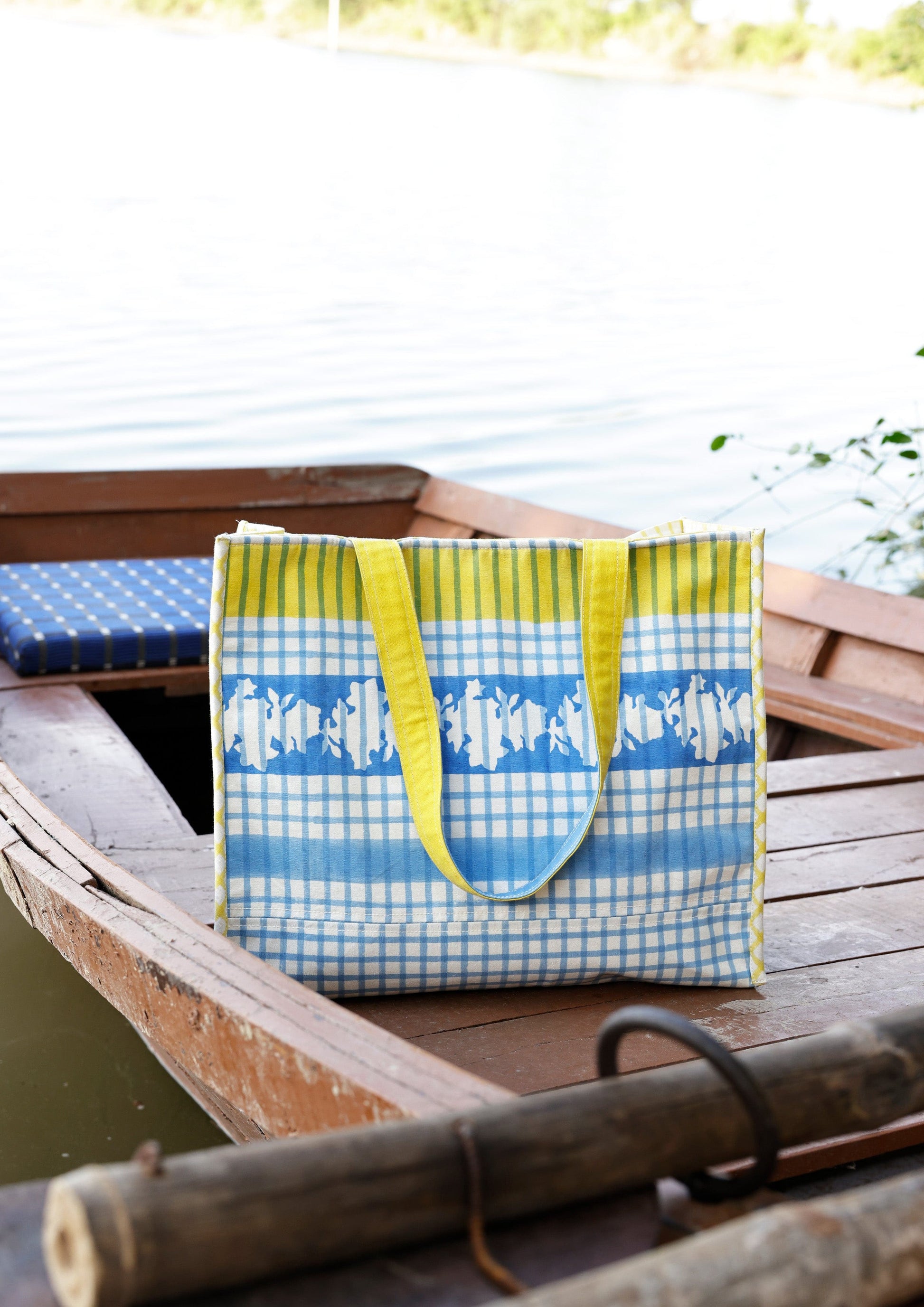 Blue checkered tote bag from The Raw India featuring a spacious design and sturdy handles.