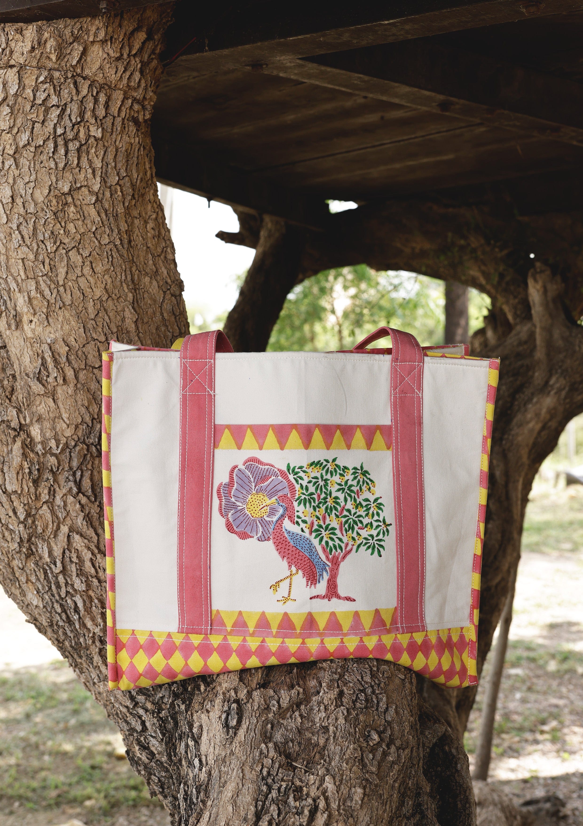 The Raw India Saras Crane tote bag featuring a vibrant crane design, made of durable fabric with sturdy handles.