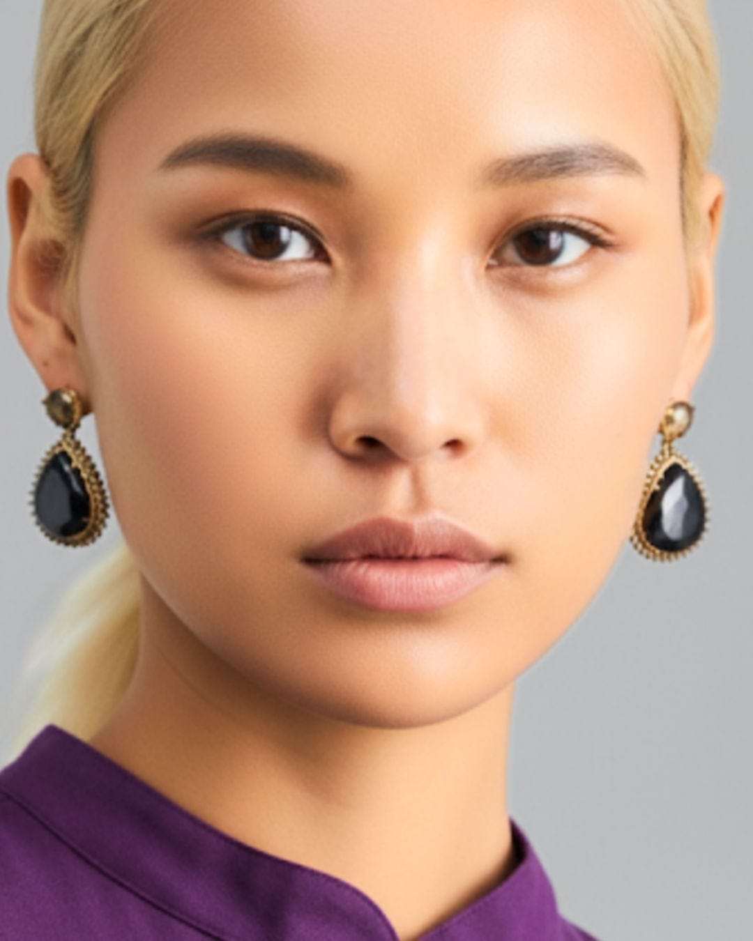 Gold Zaarah earrings by Bombaybirds featuring intricate design and dangling charms on a white background.
