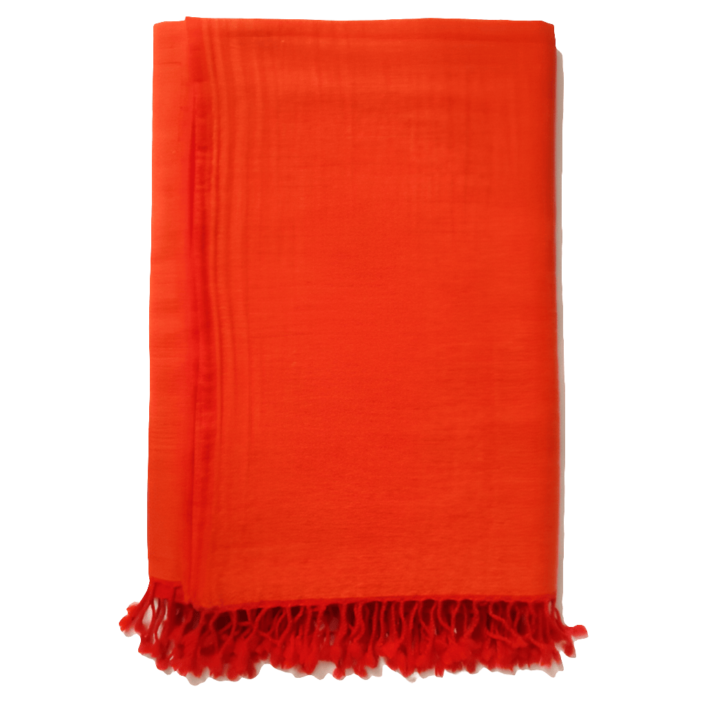 Flamed tangerine Bombaybirds throw blanket with soft fabric, draped over a living room sofa for cozy decor and comfort.