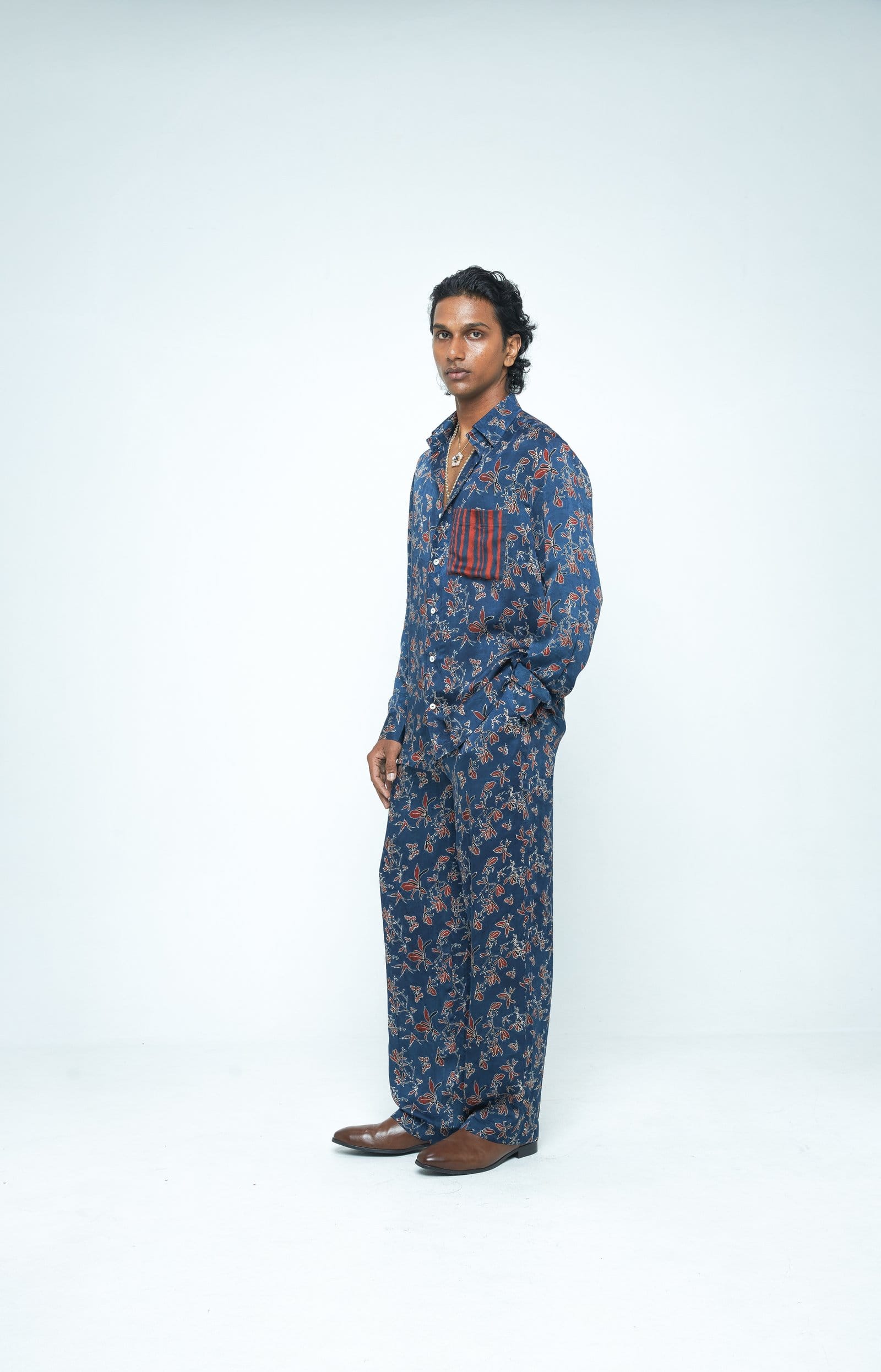 Anushe Pirani Flutter & Flow shirt shown from side view, featuring a stylish, lightweight design with flutter details.