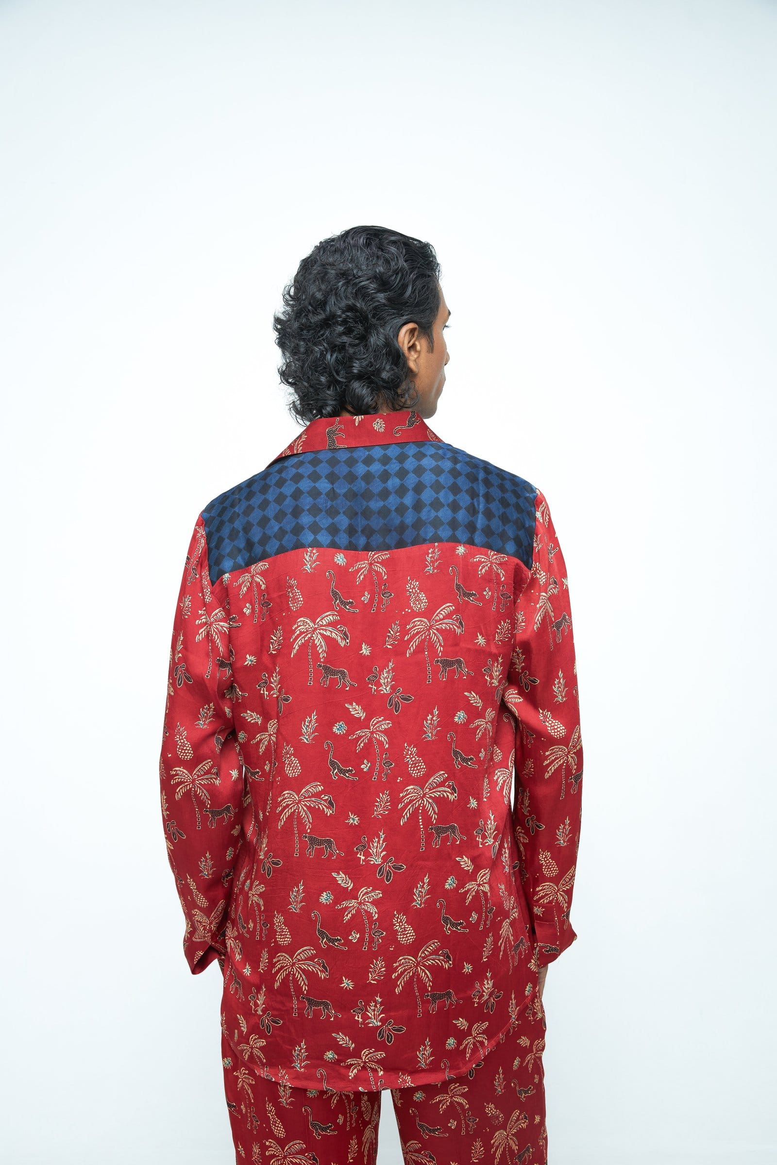 Back view of Anushe Pirani jungle shirt showing vibrant jungle print, long sleeves, and button closure.