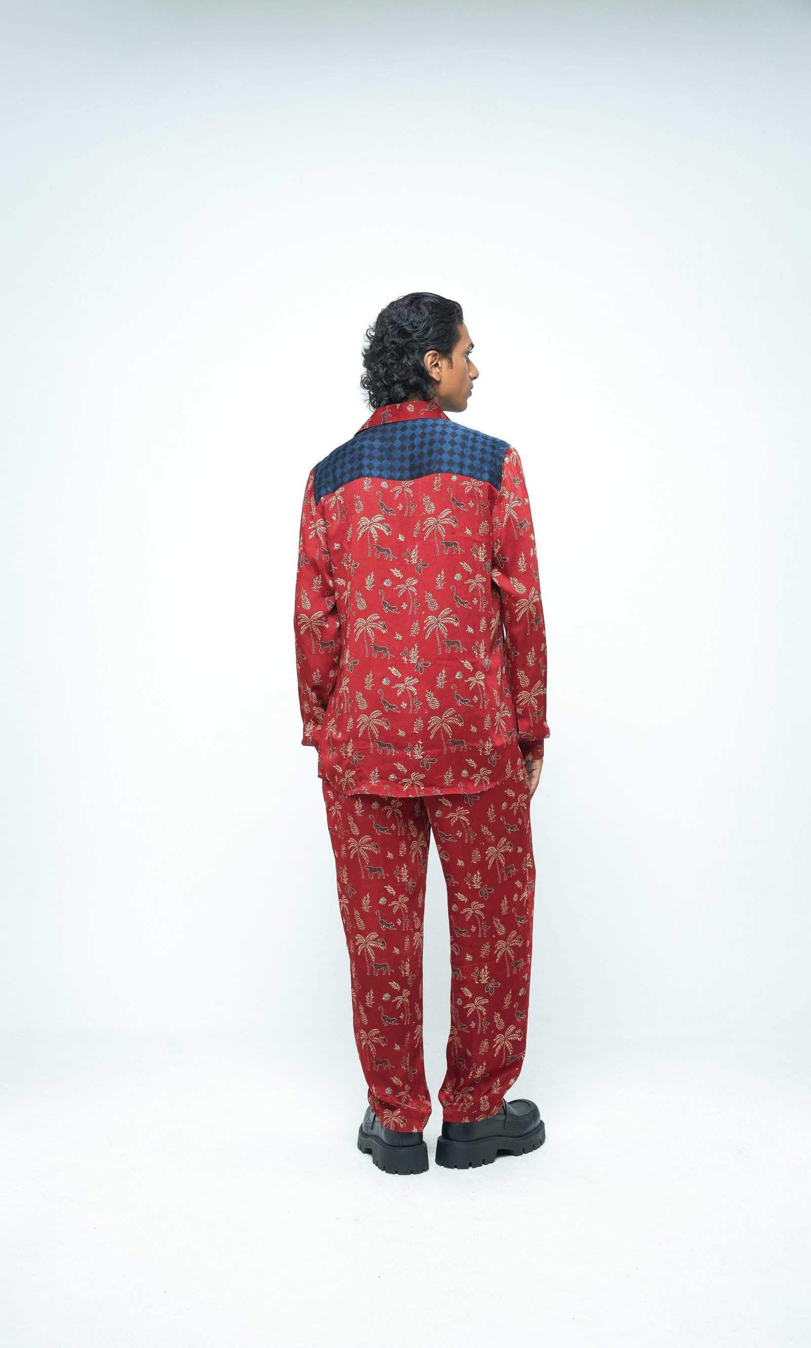 Back view of Anushe Pirani jungle shirt with vibrant jungle print fabric, showcasing long sleeves and button-down design.
