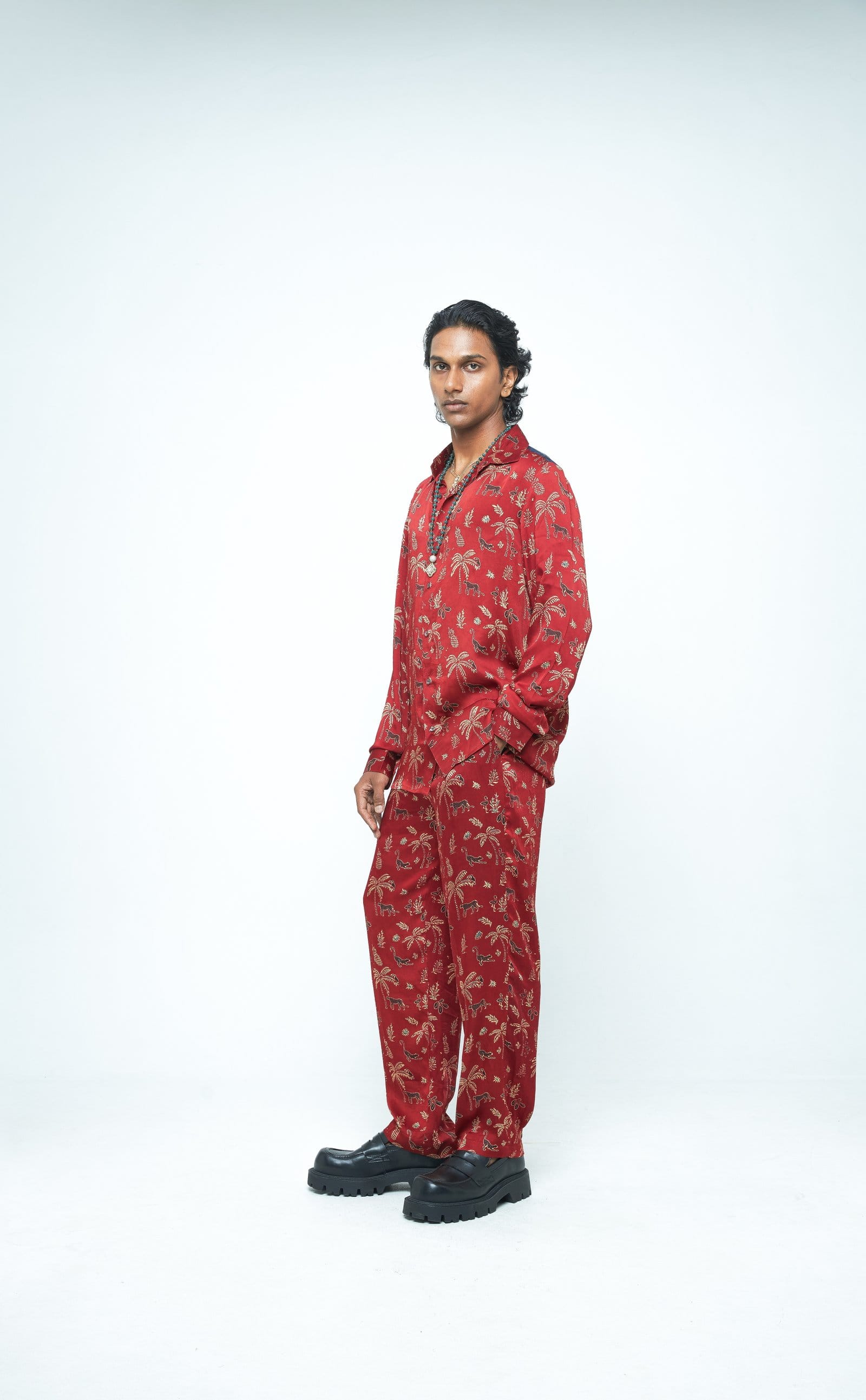 Anushe Pirani jungle-themed shirt displayed from side view, featuring vibrant print and casual fit.