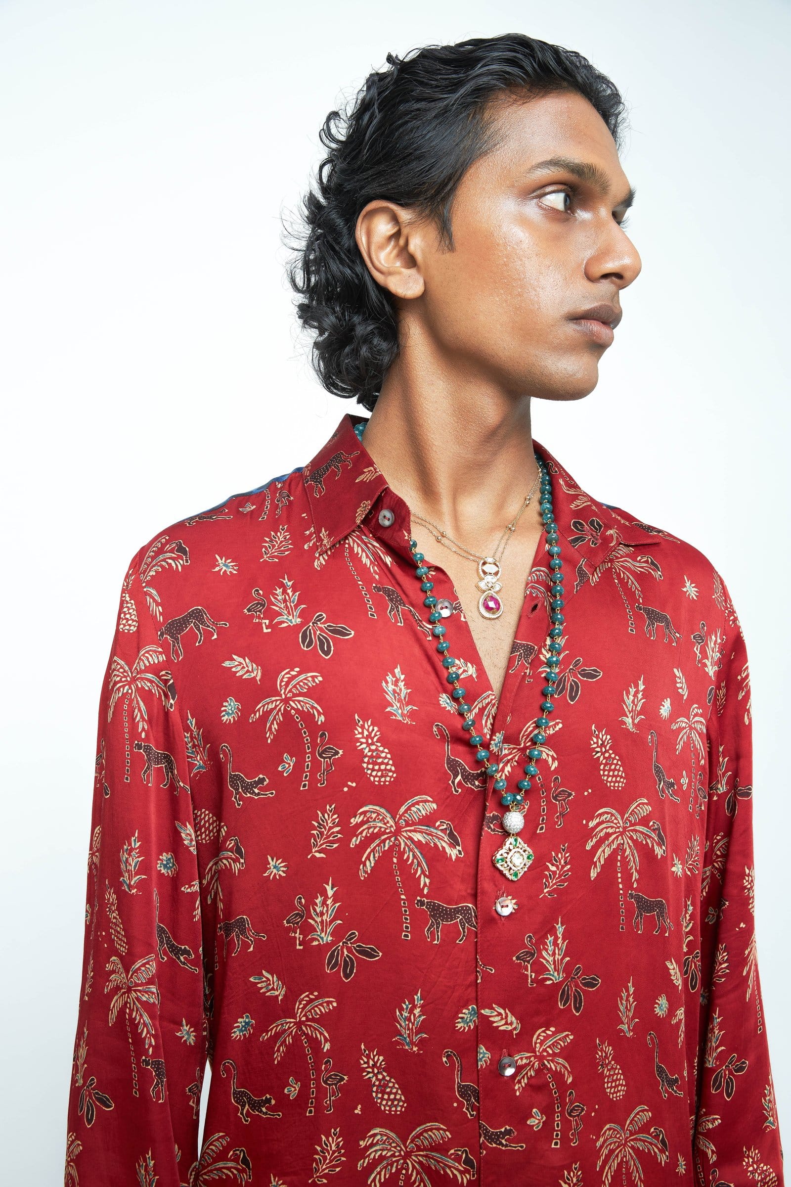 Anushe Pirani jungle shirt with vibrant green foliage print, long sleeves, and button-up front.