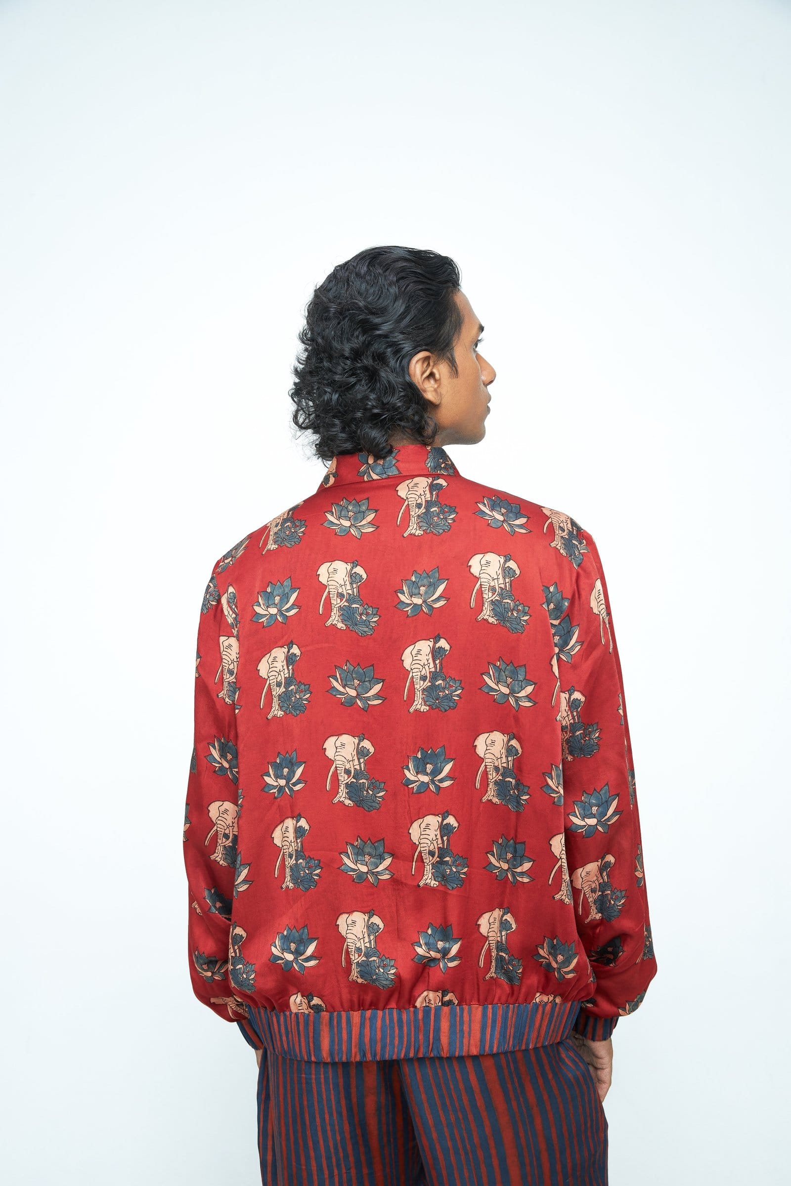Back view of Anushe Pirani rustic bomber jacket, showcasing its textured fabric and stylish design.