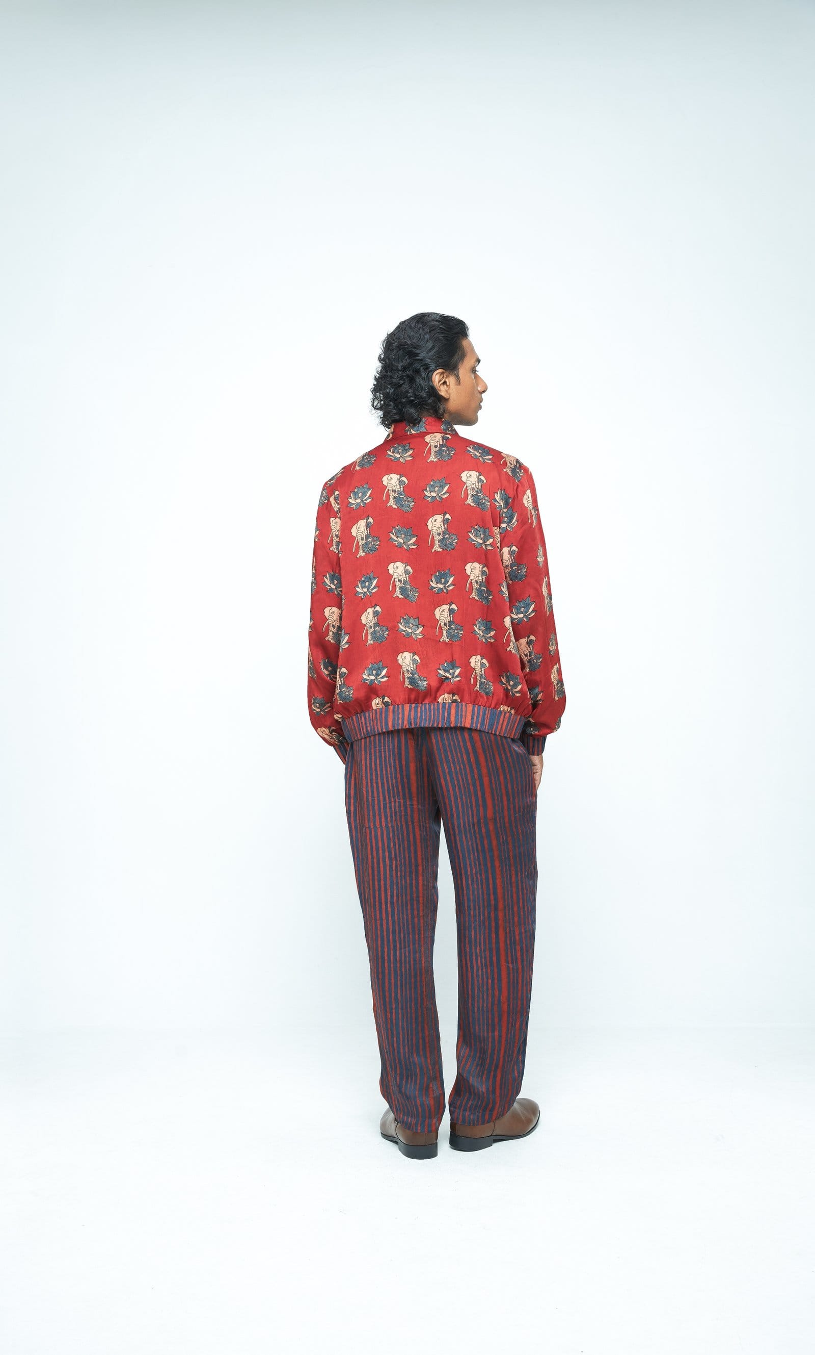 Back view of rustic bomber jacket by Anushe Pirani featuring textured fabric and a relaxed fit.