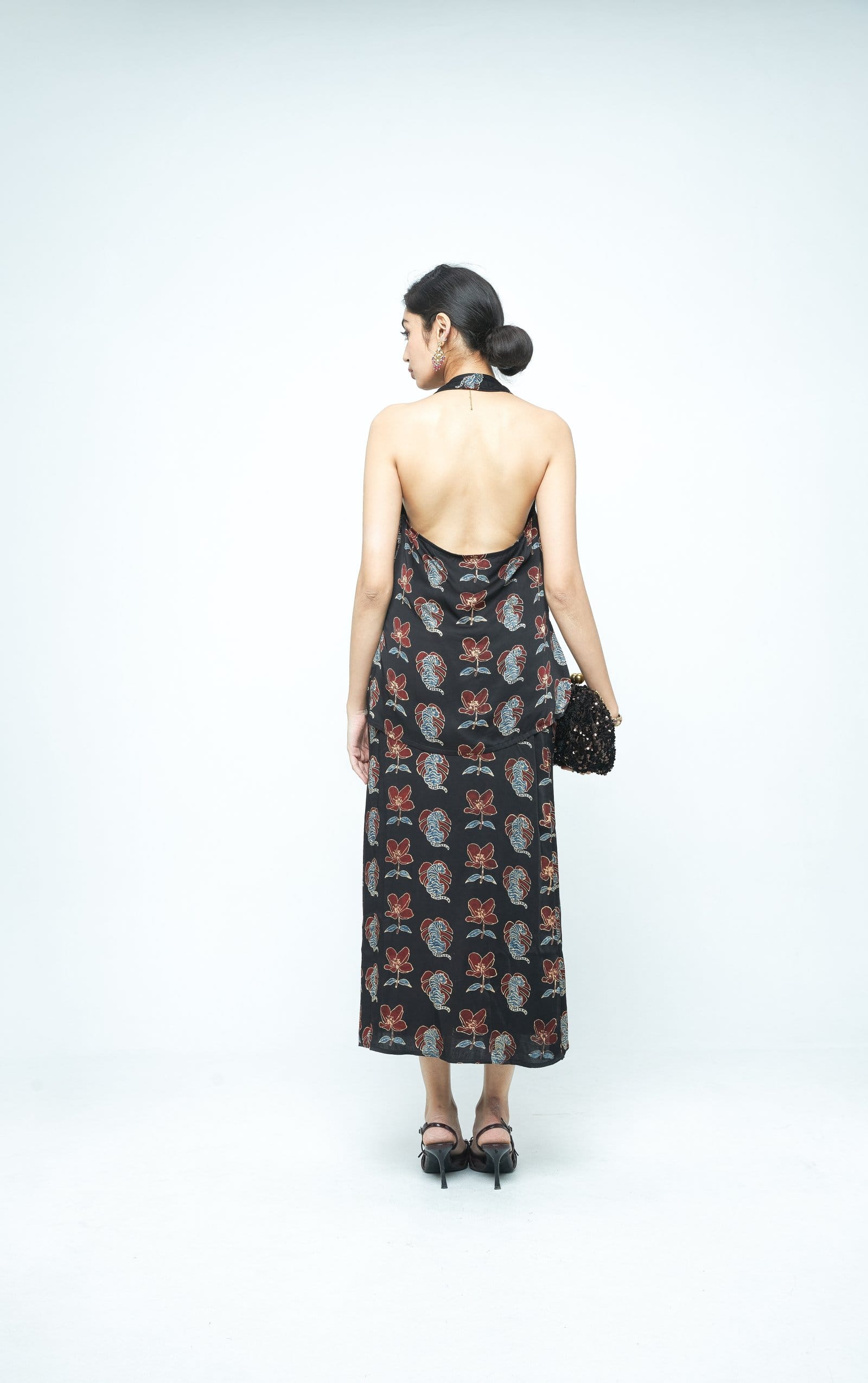 Back view of Anushe Pirani Bold halter top, featuring a stylish design with straps and fabric detail.