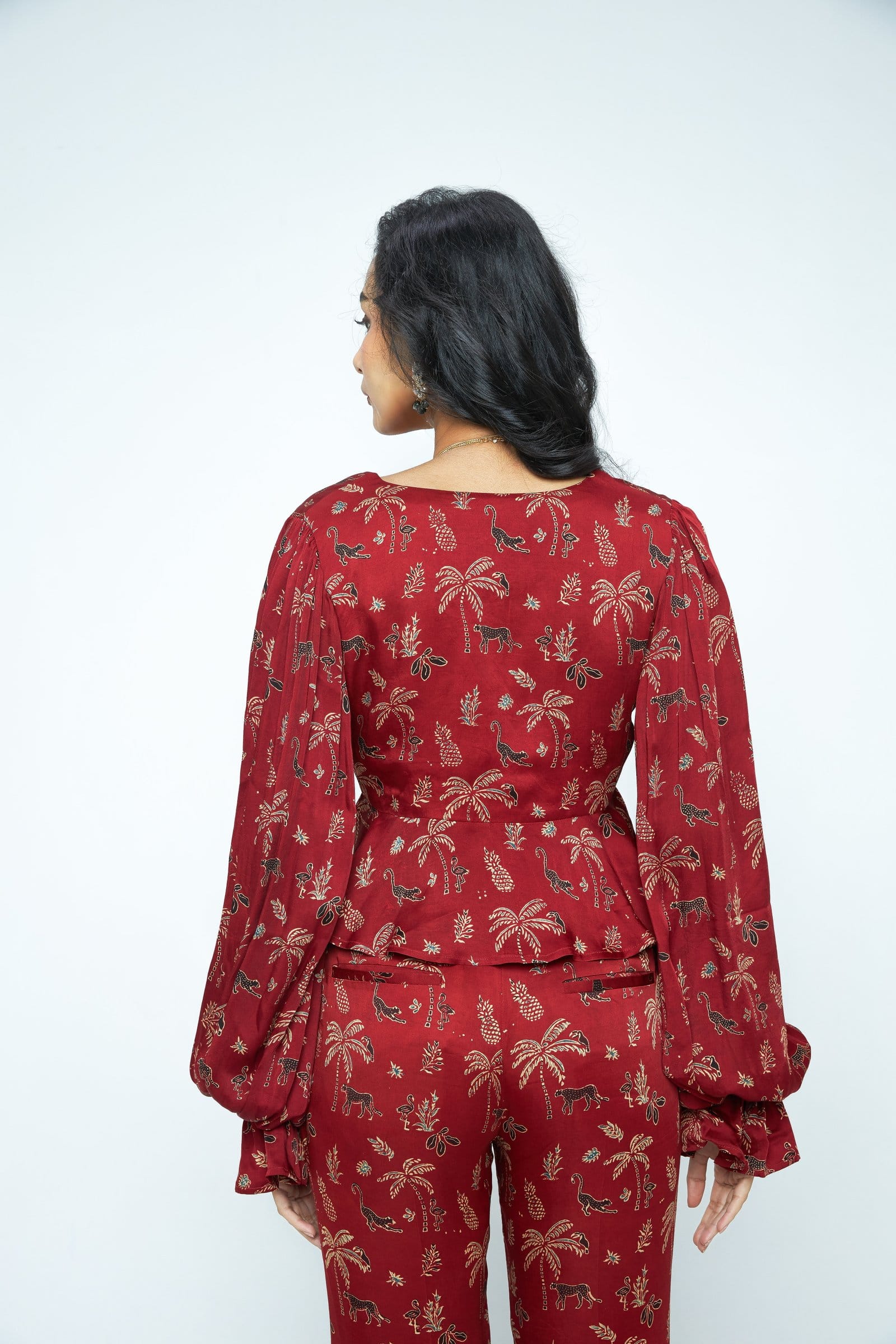 Back view of Anushe Pirani Cascade top, a stylish women's blouse with flowing fabric and elegant design.