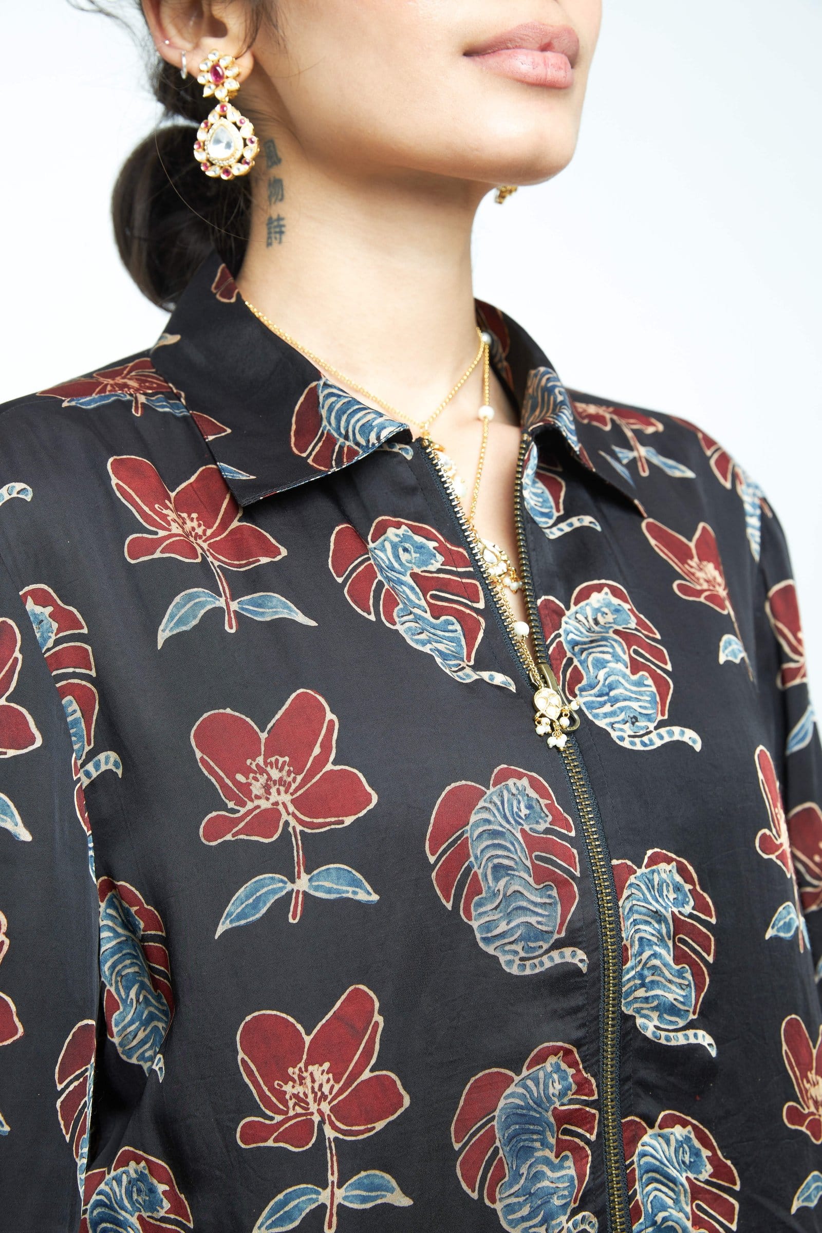 Close-up of Anushe Pirani Beast Bomber jacket showing detailed stitching and fabric texture.