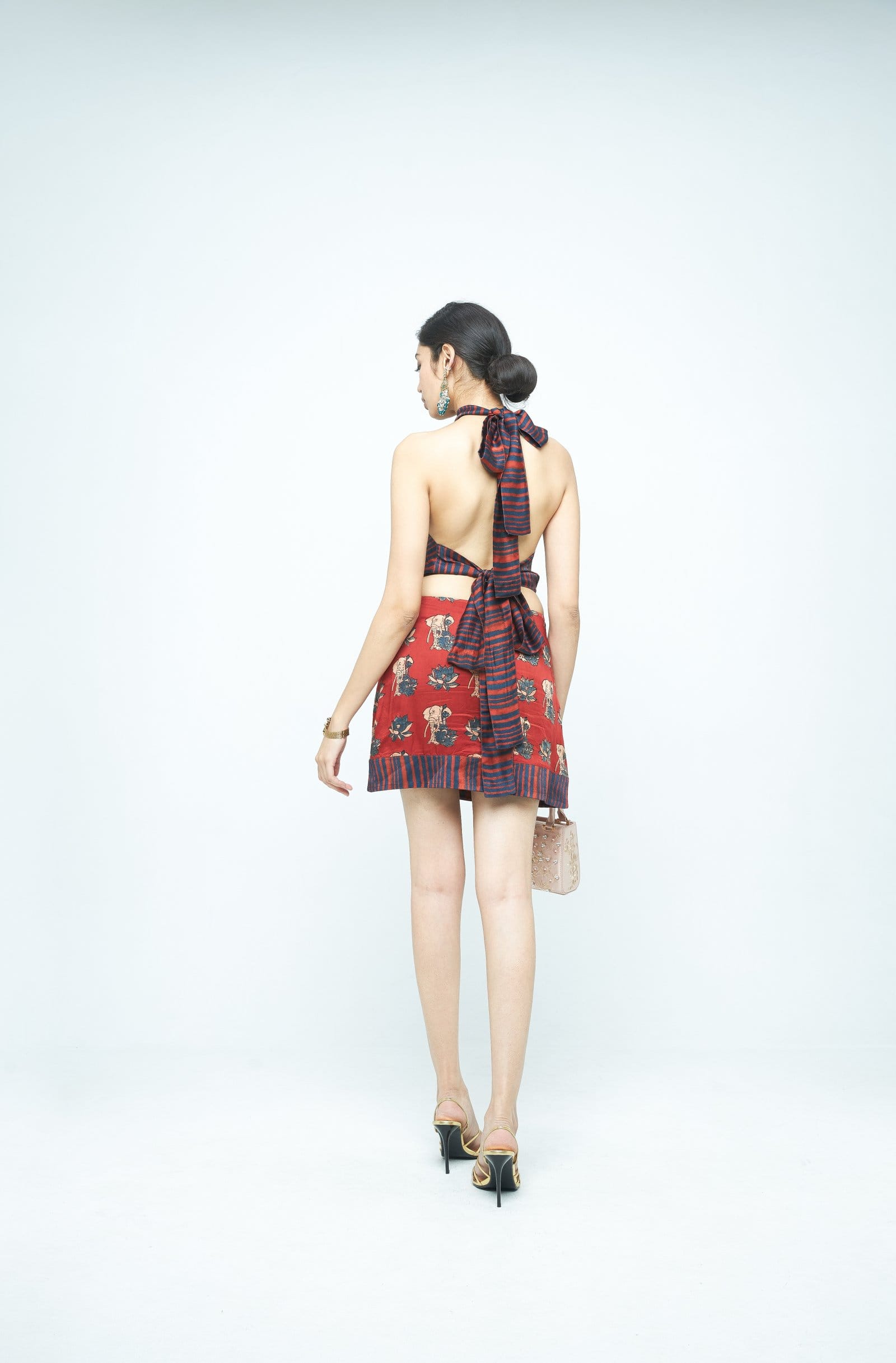 Back view of Anushe Pirani giant mini dress, stylish and flowing with intricate detailing and a fitted waist.