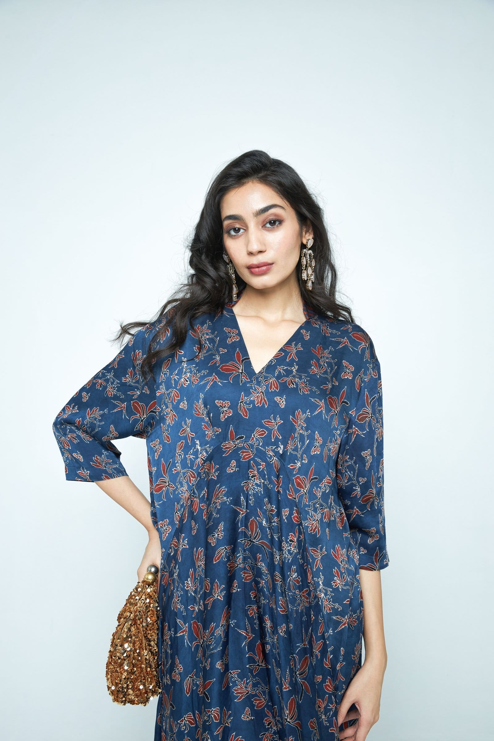 Anushe Pirani Cascade dress with flowing fabric, detailed neckline, and elegant design displayed in the product image.