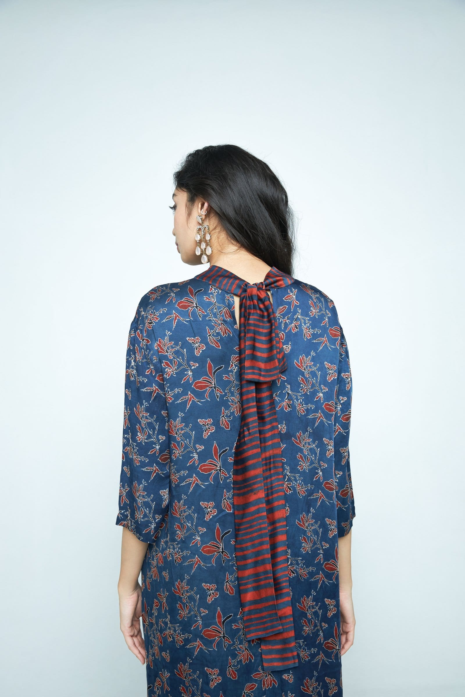 Anushe Pirani Cascade dress featuring a flowing design with intricate details, shown in a close-up view.