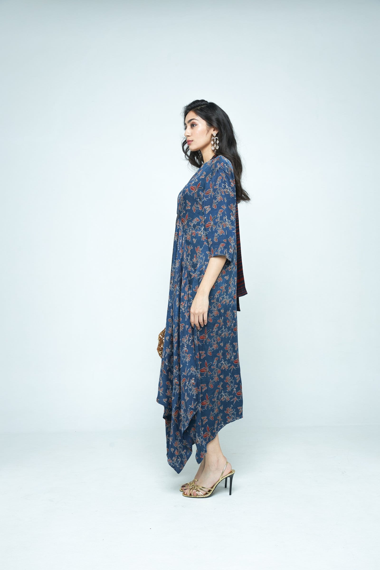 Anushe Pirani Cascade dress shown from the side, featuring flowing fabric and elegant design in a stylish dress image.