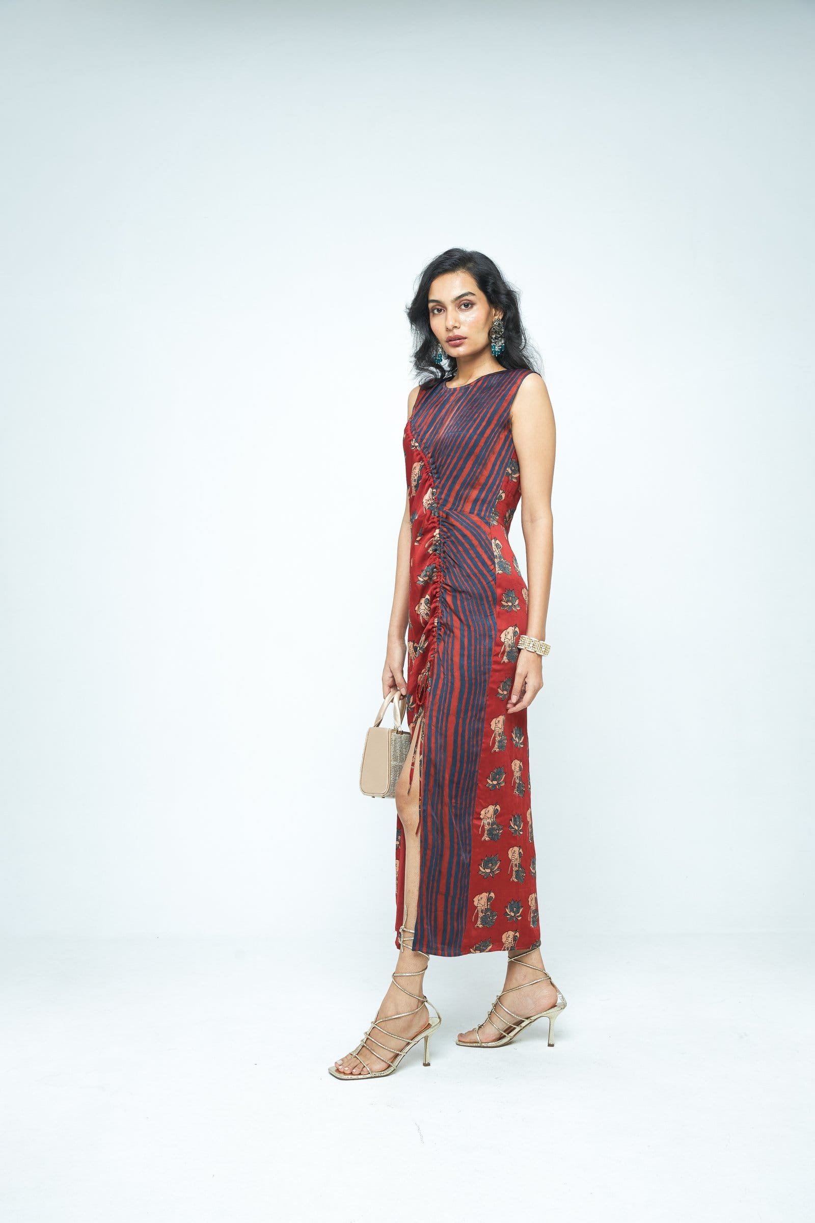 Side view of Anushe Pirani Ruché dress showcasing its elegant, flowing fabric and intricate ruching details.