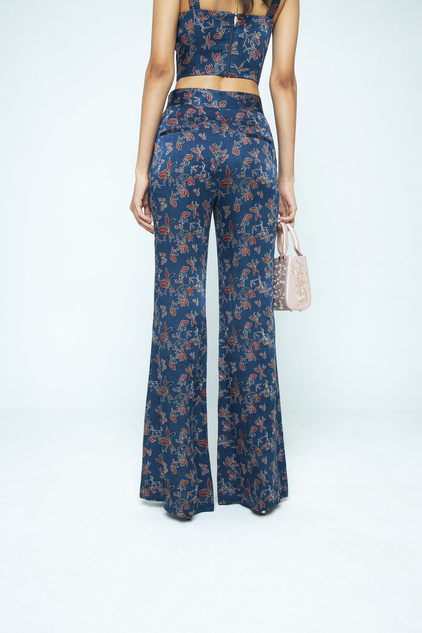 Back view of Anushe Pirani Paradise flare pants showcasing the high-waisted design and flowing fabric.