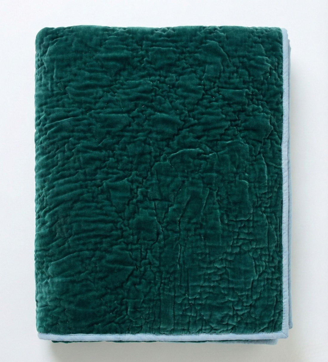 Emerald celeste velvet reversible quilt from Bombaybirds, soft and luxurious living room throw with rich green color and plush texture.