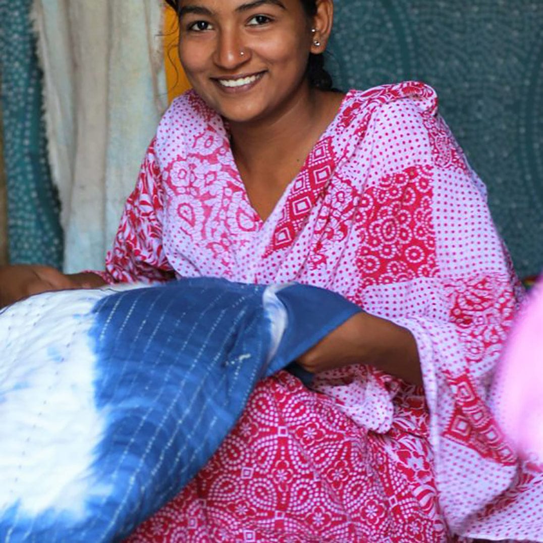 Handmade Bombaybirds Indigo Shibori quilt with traditional stitching, showcasing intricate blue fabric patterns for living room decor.